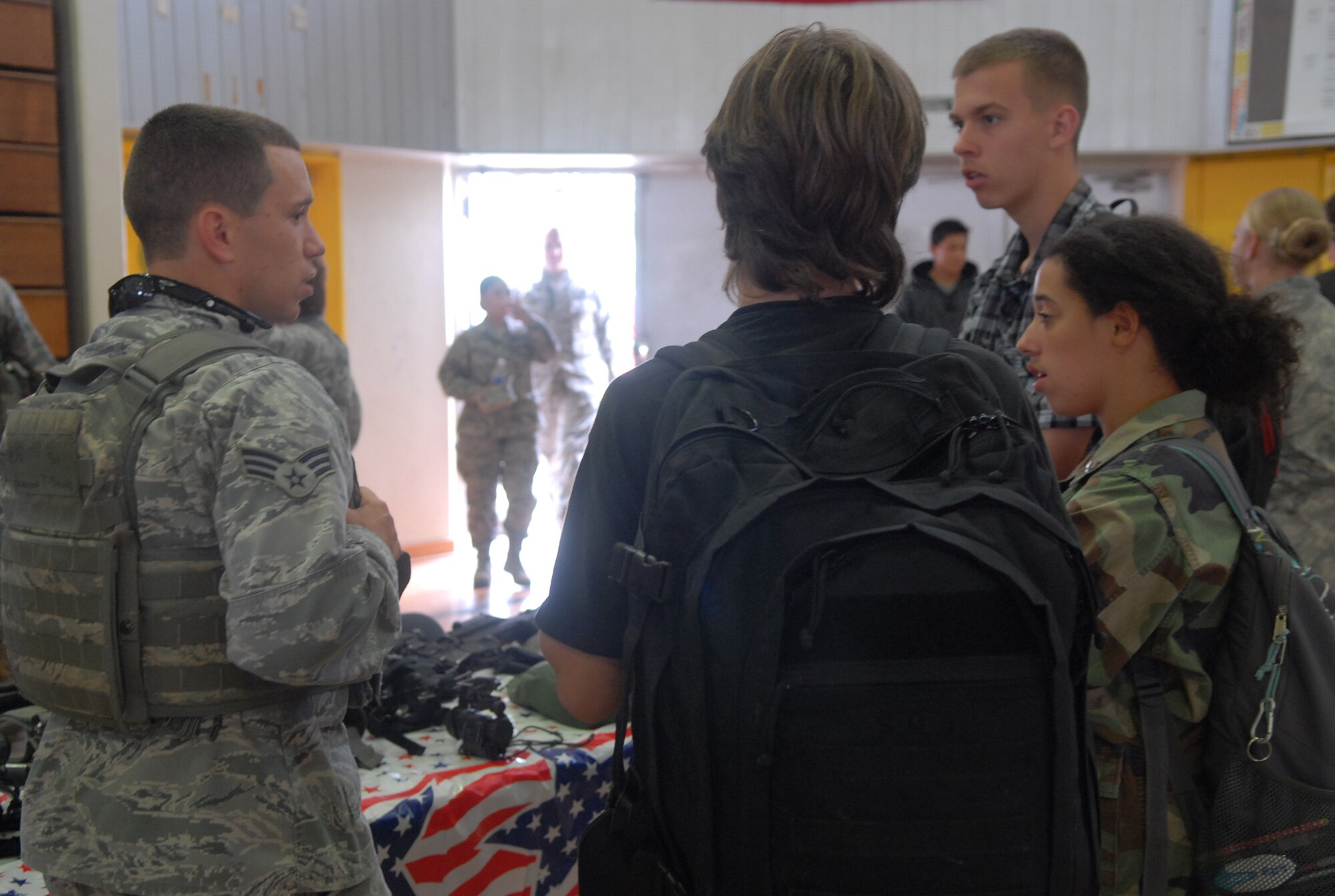U.S. Air Force Senior Airman Brandon Spears, 18th Security Forces Squadron force responder, speaks with high school students during the Kadena High School Career Day on Kadena Air Base, Japan, April 4, 2013. Hosted by the Air Force Cadet Officer Mentor Action Program, the purpose of the event was to offer a glimpse of Airmen's daily duties to possible recruits. (U.S. Air Force photo by Staff Sgt. Lauren Snyder/Released)