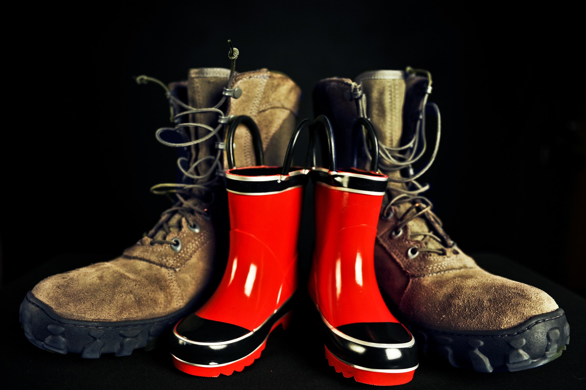 A set of boots for both father and son represent the Month of the Military Child April 10, 2013, at Buckley Air Force Base, Colo. The month is about more than just events; it is also about the experiences military children have encountered and how it has shaped them into who they are today. (U.S. Air Force photo by Airman 1st Class Riley Johnson/Released)