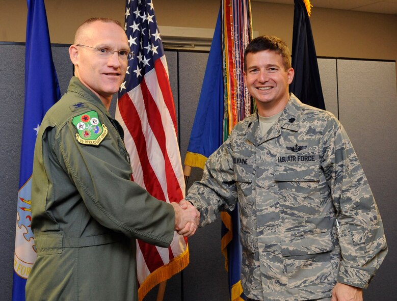 Col. Michael Adderly, 2nd Operations Support Squadron commander, presents Lt. Col. Charles McElvaine, 2 OSS, the Maj. Charles J. Loring Jr. Memorial Award for Best Overall Bomber Operation Support Squadron on Barksdale Air Force Base, La., April 10, 2013. The awards were announced via command wide VTC. (U.S. Air Force photo/Airman 1st Class Andrew Moua)