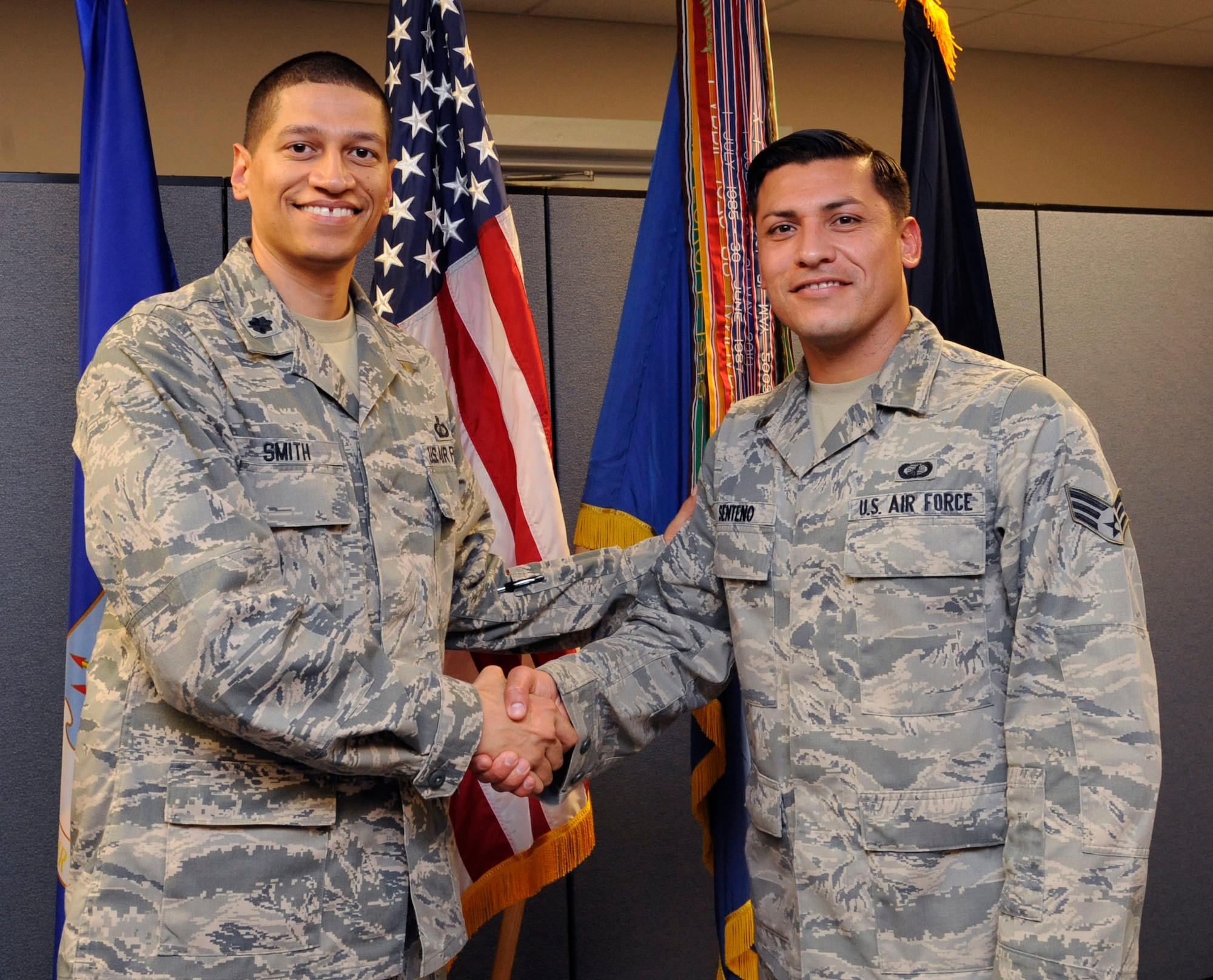 Lt. Col. Anthony Smith, 2nd Comptroller Squadron commander, presents Senior Airman Joseph Senteno, 2 CPTS, the Air Force Global Strike Command 2012 Outstanding Airman of the Year on Barksdale Air Force base, La., April 10, 2013. The awards were announced via command wide VTC. (U.S. Air Force photo/Airman 1st Class Andrew Moua)