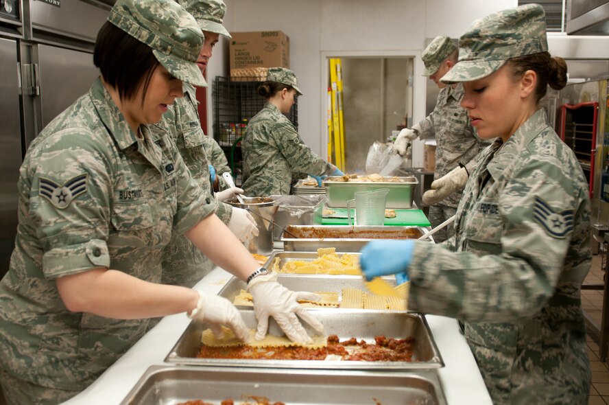 Senior Airman Sheryl Bustamante and Staff Sgt. Anya Davis of the 124th Fighter Wing Services Flight prepare lasagne that will be part of "Team Italy's" entry in the annual Iron Chef competition held May 3 at Gowen Field in Boise, Idaho.