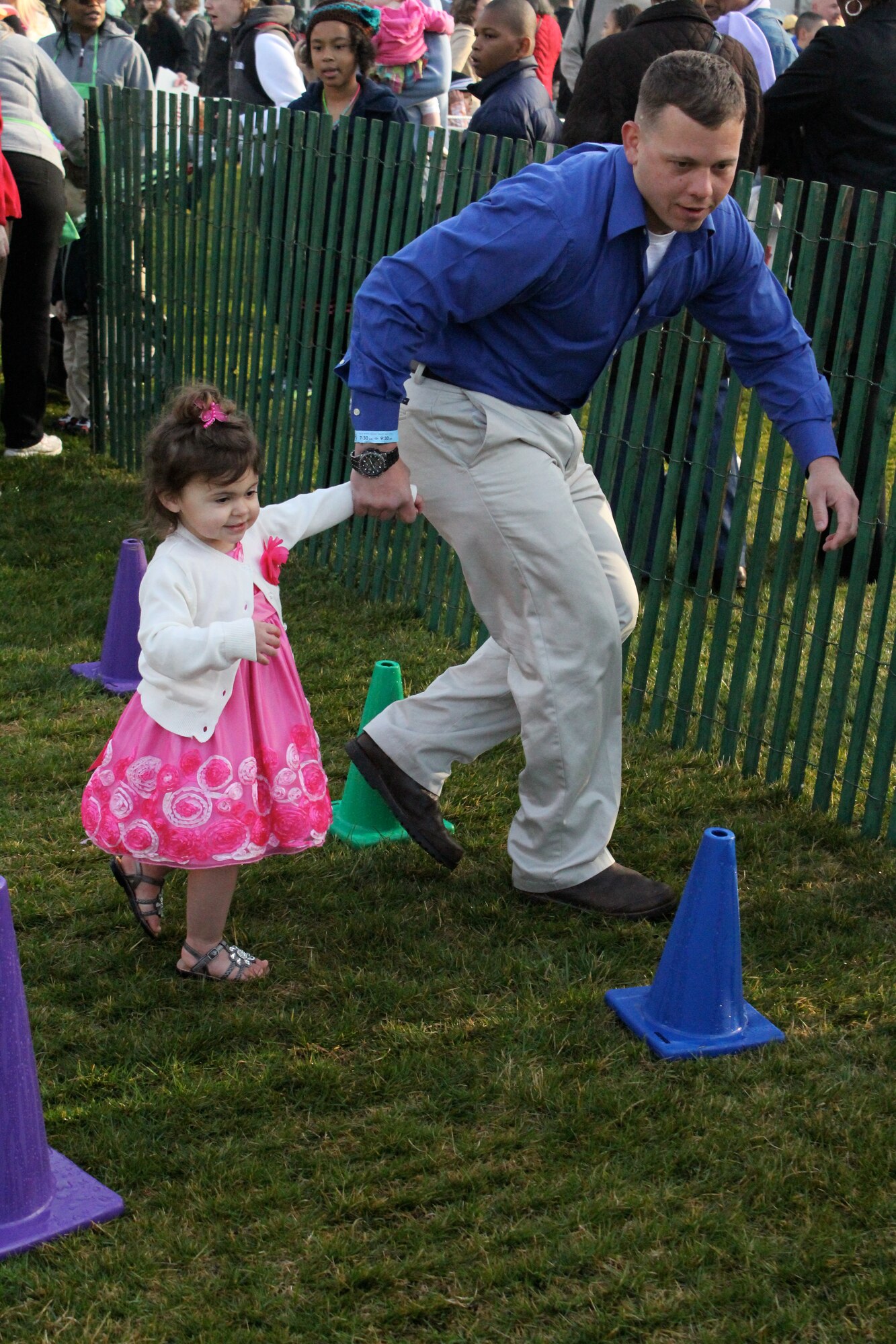 Marine Staff Sgt. Jeff Green stationed at Marine Corps Base Quantico, Va., runs through an obstacle with his daughter at the White House Easter Egg Roll in Washington, D.C., April 1, 2013.  Green’s wife, Air Force Staff Sgt. Nicole Green, Air Force District of Washington protocol, qualified for the tickets since she had deployed in the last 12 months. (Courtesy photo)