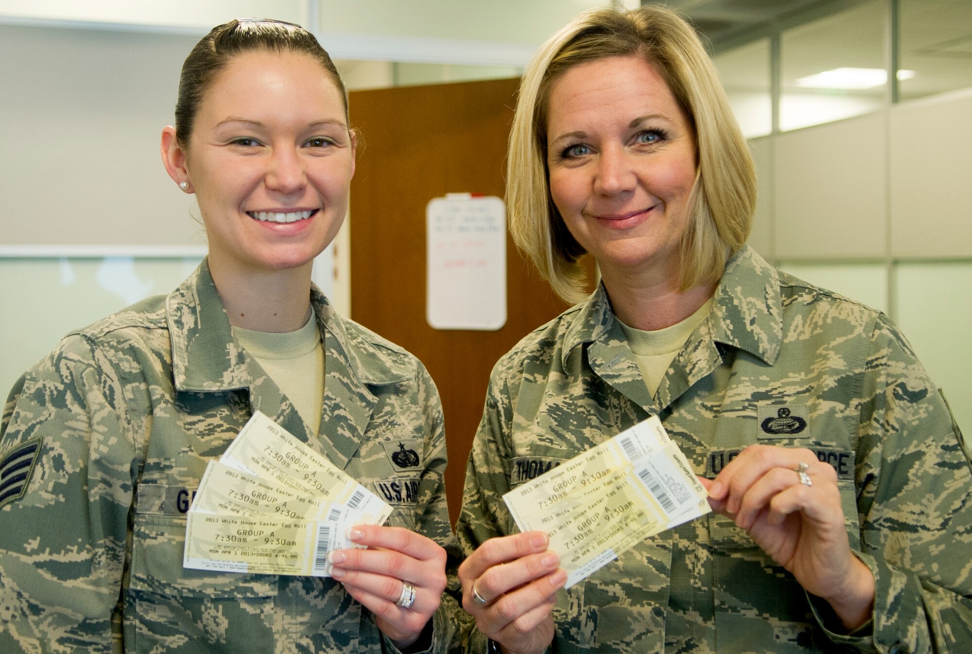 Staff Sgt. Nicole Green (left), Air Force District of Washington protocol, and Senior Master Sgt. Lisa Thomas, superintendent of personnel progress and training, pick up tickets for their families to attend the White House Easter Egg Roll March 27, 2013, at Joint Base Andrews, Md.  AFDW Airmen who deployed in the last 12 months, or are currently deployed, qualified for the opportunity for their family to attend the event. (U.S. Air Force photo by 1st Lt. Ashleigh Peck)