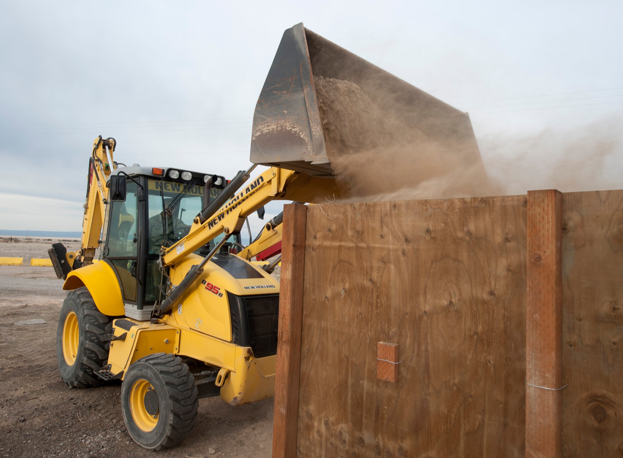 U.S. Air Force Airman 1st Class David Williams, 366th Civil Engineer Squadron pavement and equipment operator, dumps gravel into a revetment at a simulated deployed location, Mountain Home Air Force Base, Idaho, April 4, 2013. Shelters can arrive ready-to-install or are created, depending on the available materials, threat level and time. (U.S. Air Force photo/Staff Sgt. Roy Lynch) (Released)