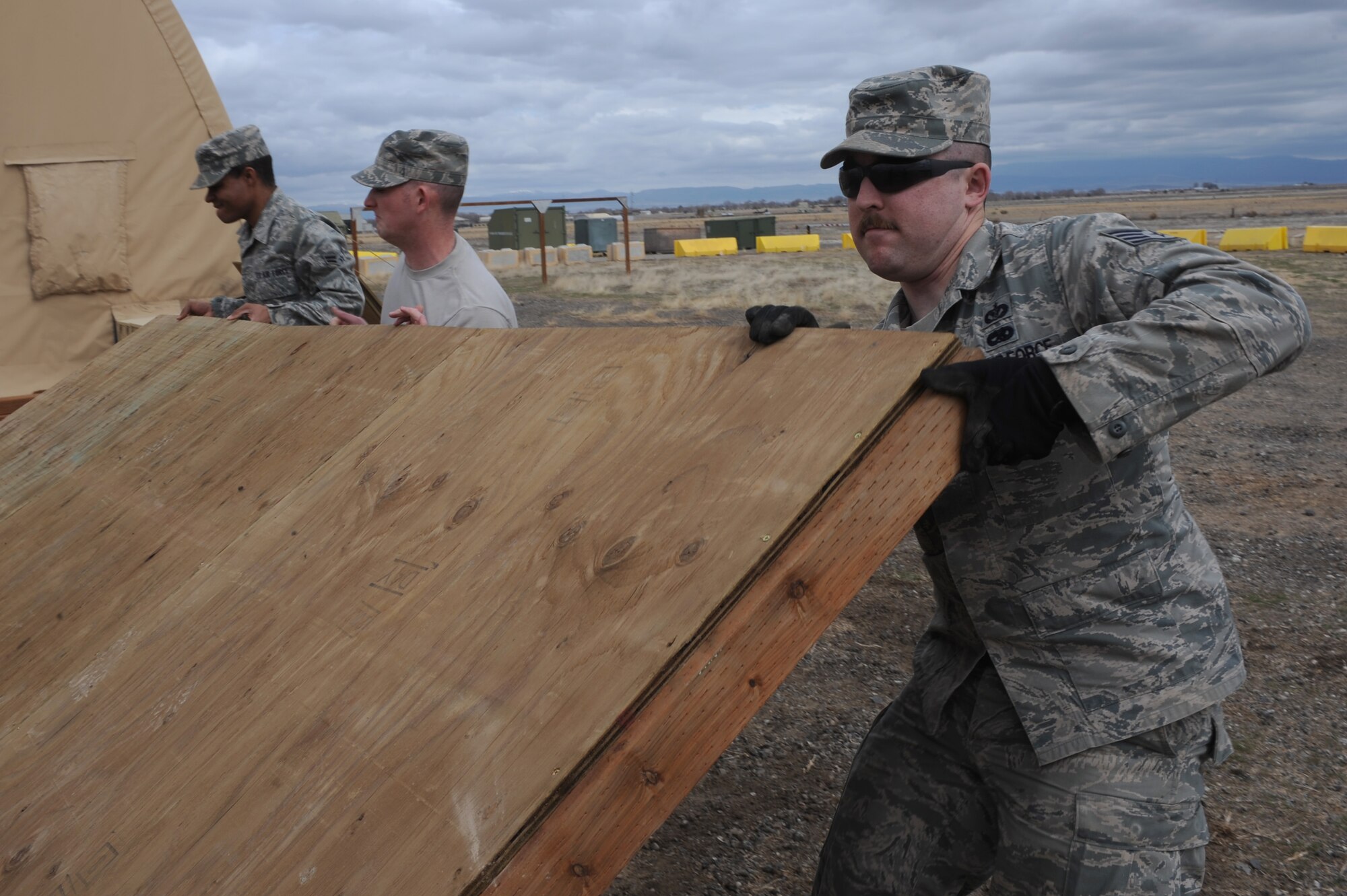 U.S. Air Force Airman 1st Class Nathan Coleman, Staff Sgt. Chris Carpenter and Staff Sgt. Kyle McCloskey, 366th Civil Engineer Squadron structures technicians, put in place a revetment wall at a simulated deployed location, Mountain Home Air Force Base, Idaho, April 1, 2013. Revetments are essential in protecting base assets and personnel down range. (U.S. Air Force photo/Staff Sgt. Roy Lynch) (Released)