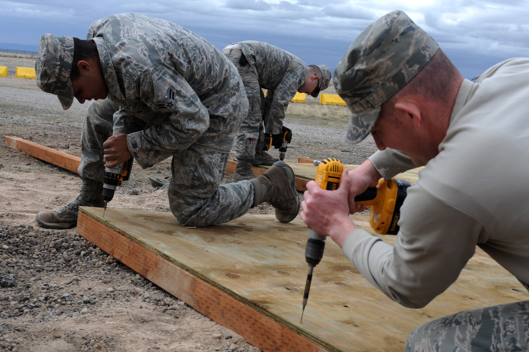 U.S. Air Force Airman 1st Class Nathan Coleman, Staff Sgt. Kyle McCloskey and Staff Sgt. Chris Carpenter, 366th Civil Engineer Squadron structures technicians, prepare a revetment wall at a simulated deployed location, Mountain Home Air Force Base, Idaho, April 1, 2013. The 366th Fighter Wing is required to protect military assets in the upcoming Certified Readiness Exercise and this revetment meets that requirement. (U.S. Air Force photo/Staff Sgt. Roy Lynch) (Released)