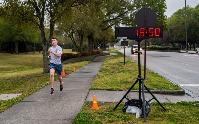 Airman 1st Class John Snyder, 437th Maintenance Squadron crew chief, crosses the finish line during the 5k Commander's Challenge Run April 5, 2013, at Joint Base Charleston – Air Base, S.C. Snyder finished as the top male participant with a time of 18:50. (U.S. Air Force photo/ Senior Airman George Goslin)