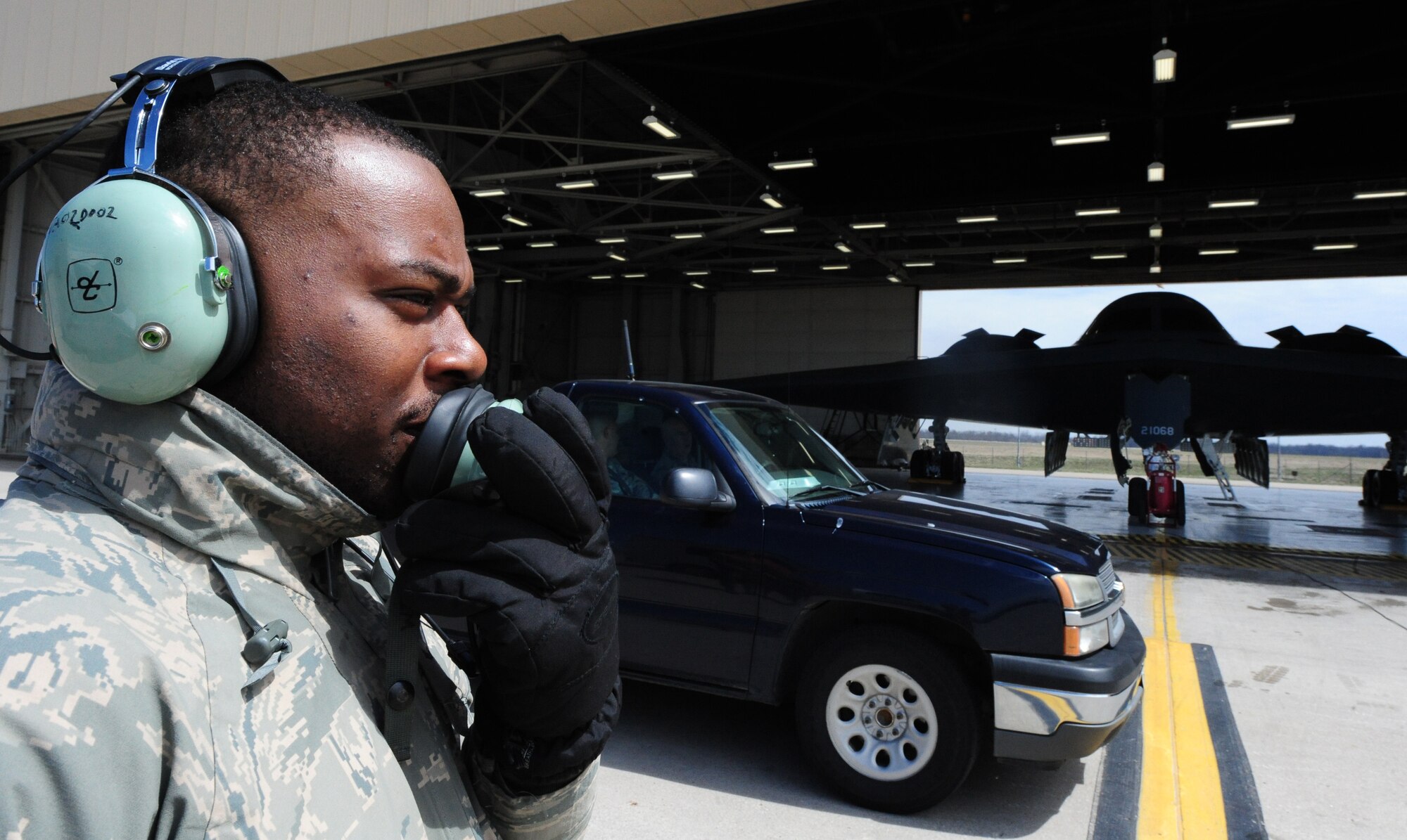 Airman 1st Class Steven McCray, 13th Aircraft Maintenance Unit B-2 Spirit crew chief, speaks to his pilot through a headset and communications cord during a pre-flight inspection at Whiteman Air Force Base, April 5, 2013. During preflight inspections, crew chiefs review a checklist with pilots to ensure the aircraft is free from any abnormalities. (U.S. Air Force photo by Staff Sgt. Nick Wilson/Released) 