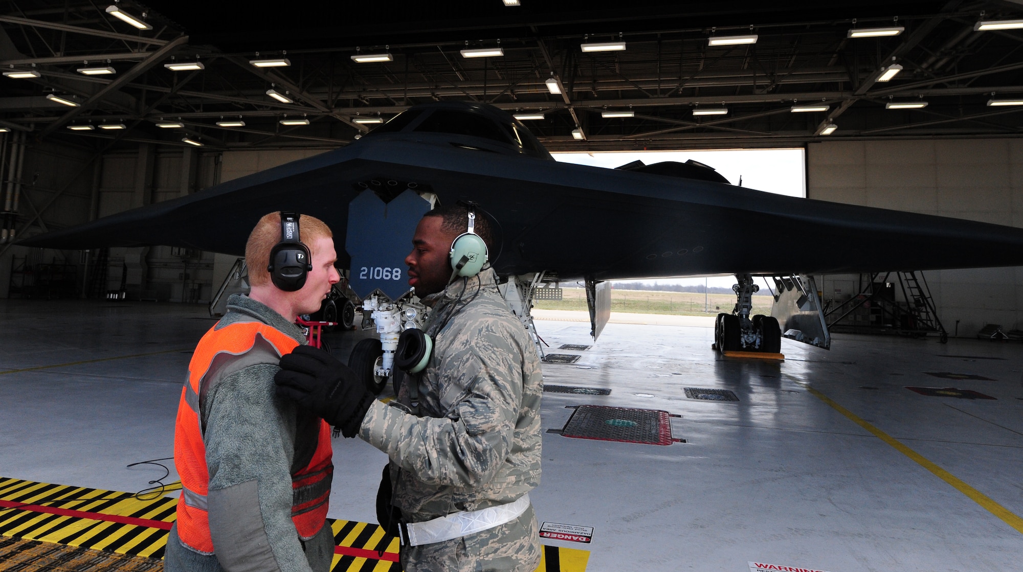 Airmen 1st Class James Fulton and Steven McCray and James Fulton, 13th Aircraft Maintenance Unit crew chiefs, discuss launch operations during a pre-flight inspection at Whiteman Air Force Base, April 5, 2013. Fulton and McCray are two of more than 160 crew chiefs that are responsible for ensuring each B-2 assigned to Whiteman Air Force Base is mission-ready. (U.S. Air Force photo by Staff Sgt. Nick Wilson/Released)