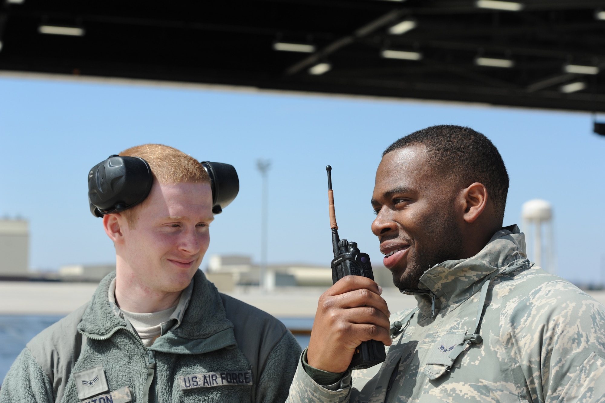Airmen 1st Class James Fulton and Steven McCray and James Fulton, 13th Aircraft Maintenance Unit crew chiefs, notify the maintenance operations center that a B-2 Spirit they just marshaled is ready for flight, Whiteman Air Force Base, April 5, 2013. Fulton and McCray are two of more than 160 crew chiefs responsible for ensuring each B-2 assigned to Whiteman Air Force Base is mission-ready. (U.S. Air Force photo by Staff Sgt. Nick Wilson/Released)



