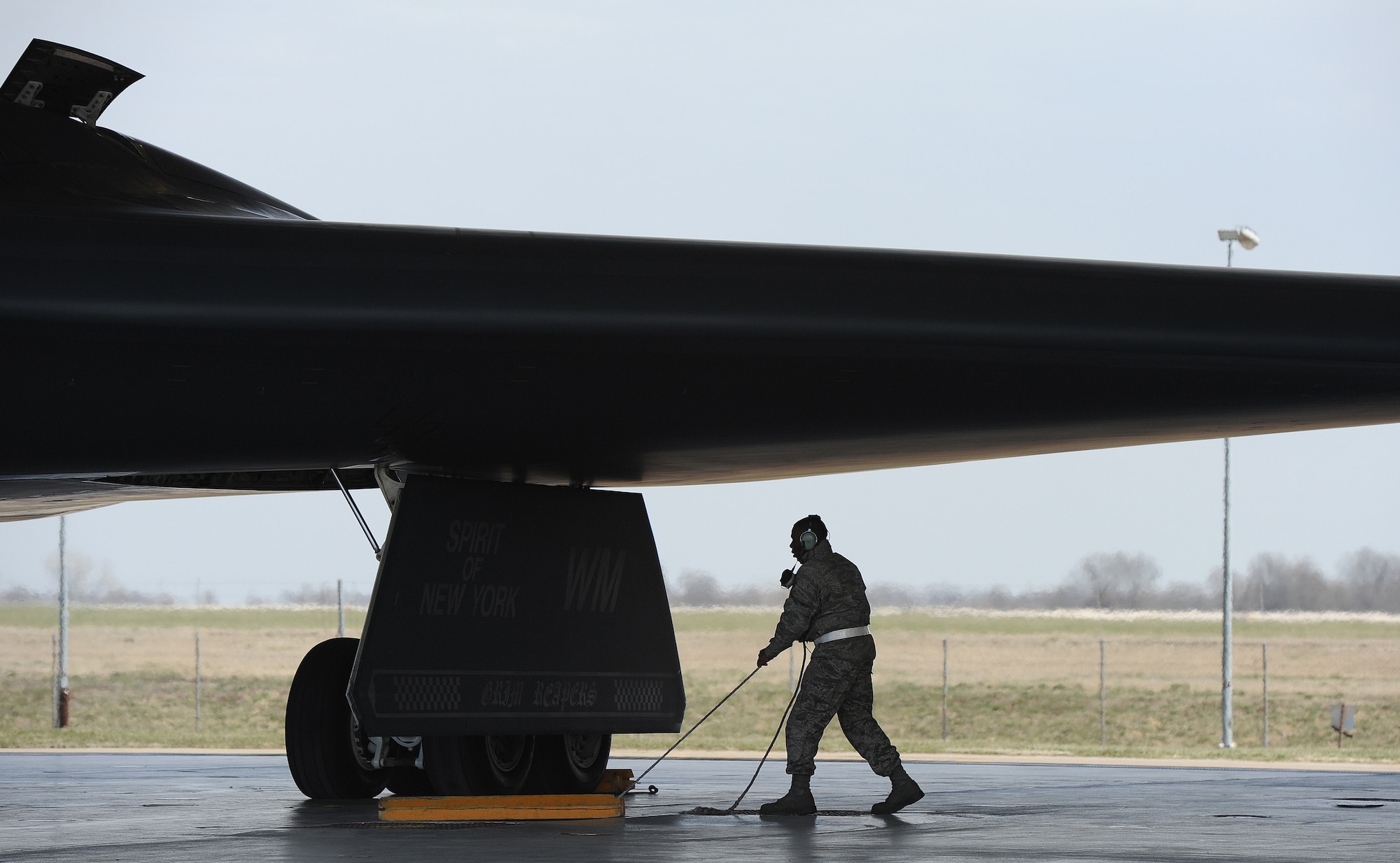 Airman 1st Class Steven McCray, 13th Aircraft Maintenance Unit B-2 Spirit crew chief, removes chalks before performing launch operations on a B-2 Spirit, Whiteman Air Force Base, April 5, 2013. McCray is 23 years old and has been a crew chief in the Air Force for two years. (U.S. Air Force photo by Staff Sgt. Nick Wilson/Released)





