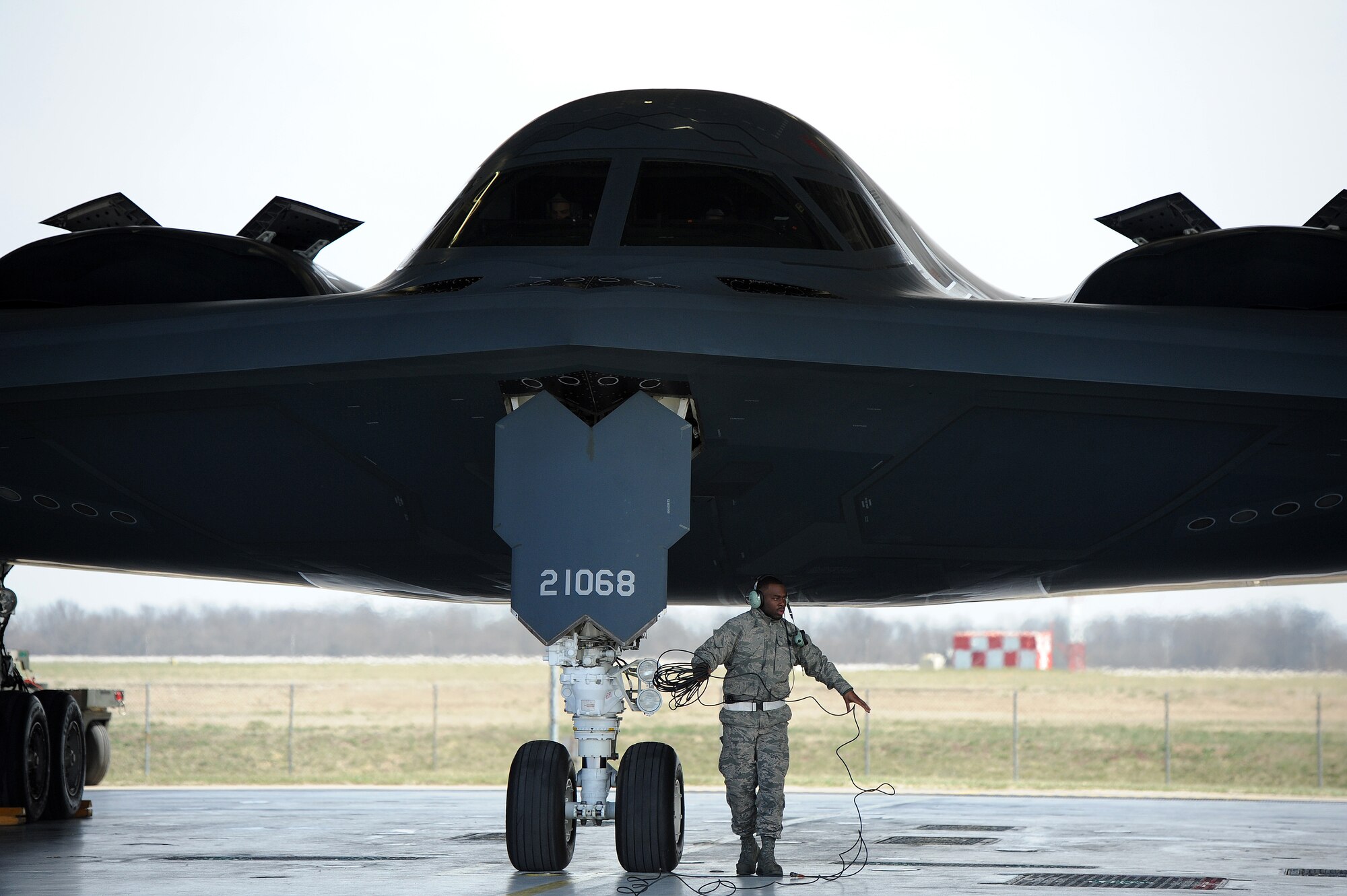 Airman 1st Class Steven McCray, 13th Aircraft Maintenance Unit B-2 Spirit crew chief, rolls up a communication cord after performing pre-flight checks, Whiteman Air Force Base, April 5, 2013.  Because of their mission and constant operations tempo, B-2 crew chiefs must remain alert and aware of every maintenance issue on their assigned aircraft. (U.S. Air Force photo by Staff Sgt. Nick Wilson/Released)






