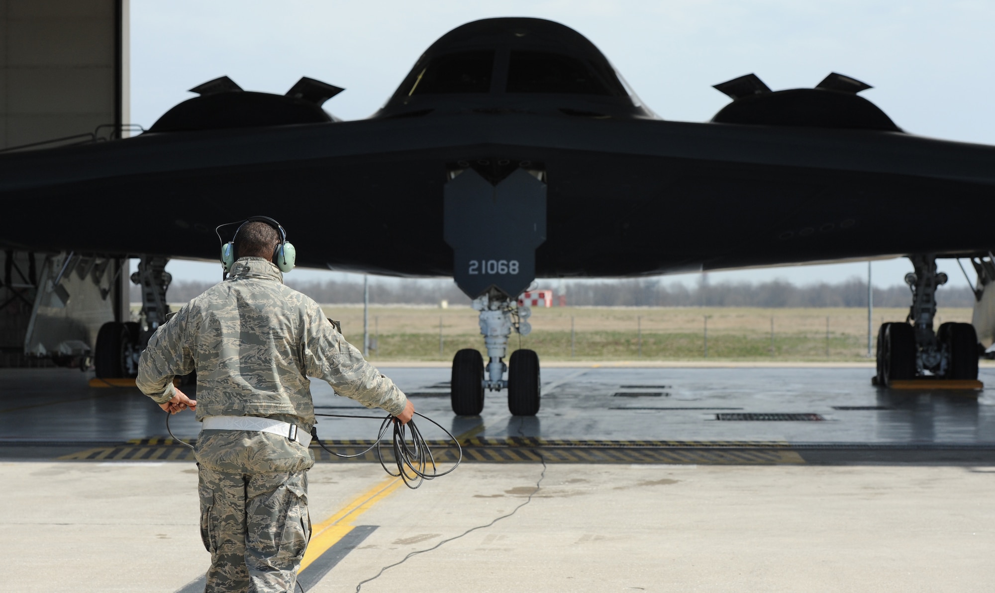 Airman 1st Class Steven McCray, 13th Aircraft Maintenance Unit B-2 Spirit crew chief, rolls up a communication cord after performing pre-flight checks at Whiteman Air Force Base, April 5, 2013.  Because of their mission and constant operations tempo, B-2 crew chiefs must remain alert and aware of every maintenance issue involving their assigned aircraft. (U.S. Air Force photo by Staff Sgt. Nick Wilson/Released)







