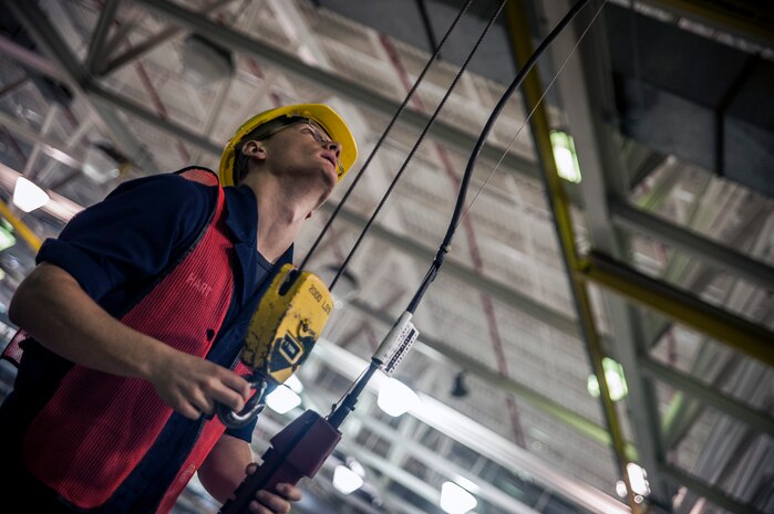 Seaman Jared Hart, Navy Munitions Command Unit Charleston machinist’s mate, conducts crane operations to move an assembled mine to the delivery staging area during a bi-annual Mine Readiness Certification April 1, 2013, at Joint Base Charleston – Weapons Station, S.C. (U.S. Air Force photo / Airman 1st Class Tom Brading)