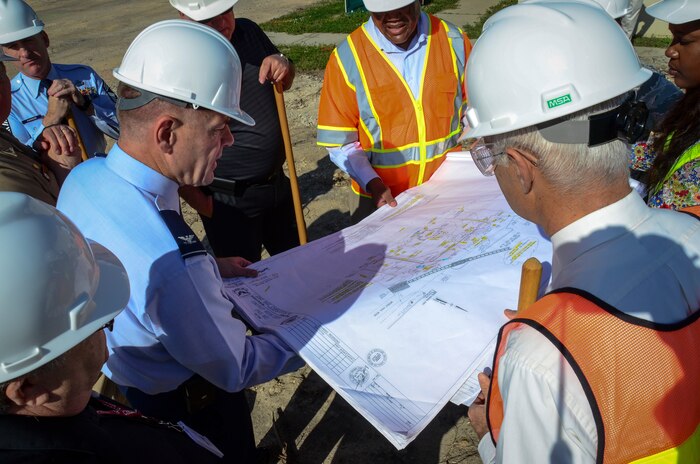 Col. Richard McComb, Joint Base Charleston commander, reviews the layout of the new Visitor Center with project officers after a ground-breaking ceremony, April 10, 2013 at Joint Base Charleston – Weapons Station, S.C. The new facility will provide employees with a modern badge, pass and Defense Biometrics Identification System work area. The visitor’s lobby/waiting area will provide comfortable and convenient seating, drinking fountains and restrooms. The dedicated parking lots will be located at the front and beside the new building and will provide convenient parking. The new one-story building will also be built to meet current anti-terrorism force protection requirements. The project is expected to be completed by October 2013. (U.S. Air Force photo/Staff Sgt. Anthony Hyatt)