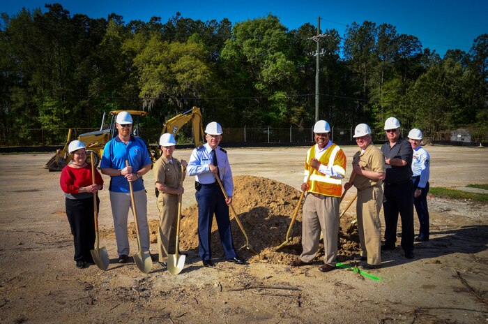 Joint Base Charleston leadership and project officers gather during a ground-breaking ceremony for the new Visitor Center April 10, 2013, at Joint Base Charleston – Weapons Station, S.C. Pictured (from left to right) are Kathy Sorenson, 628th Security Forces Squadron office manager for pass and identification, Robert Trout, 628th SFS chief of plans and programs, Master Chief Petty Officer Billy Cady, JB Charleston – Weapons Station command master chief, Col. Richard McComb, JB Charleston commander, Walter Johnson, BES Construction superintendent, Navy Capt. Thomas Bailey, JB Charleston deputy commander, Sandy Ford, 628th Contracting Squadron officer, and Chief Master Sgt. Earl Hannon, 628th Air Base Wing command chief. The new facility will provide employees with a modern badge, pass and Defense Biometrics Identification System work area. The visitor’s lobby/waiting area will provide comfortable and convenient seating, drinking fountains and restrooms. The dedicated parking lots will be located at the front and beside the building and will provide convenient parking. The new one-story building will also be built to meet current anti-terrorism force protection requirements. The project is expected to be completed by October 2013. (U.S. Air Force photo/Staff Sgt. Anthony Hyatt)