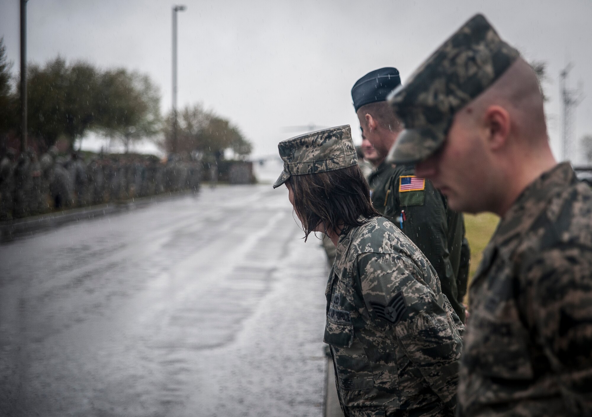 Airmen brave the rain and wind as they fall into formation along Hill Blvd. following  a Dignified Transfer ceremony April, 4, 2013,  at Joint Base Charleston – Air Base, S.C. The Airmen were showing their respect to U.S. Army Chief Warrant Officer 5th Class Curtis Reagan, 43, of Summerville, S.C., who died March 29, 2013, in Kandahar, Afghanistan, from a non-combat related illness. Reagan’s remains were flown from Dover, Del., to Charleston. (U.S. Air Force photo/ Senior Airman Dennis Sloan)