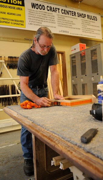 Mike Jarrett, 2nd Force Support Squadron woodcrafts center manager, secures the frame of a shadowbox on Barksdale Air Force Base, La., April 10, 2013. The wood craft shop makes shadow boxes, podiums, trophy cases and coin racks. Every month, the wood craft shop offers a four-day woodworking class where beginners can be certified to use woodworking equipment. (U.S. Air Force photo/Airman 1st Class Andrew Moua)