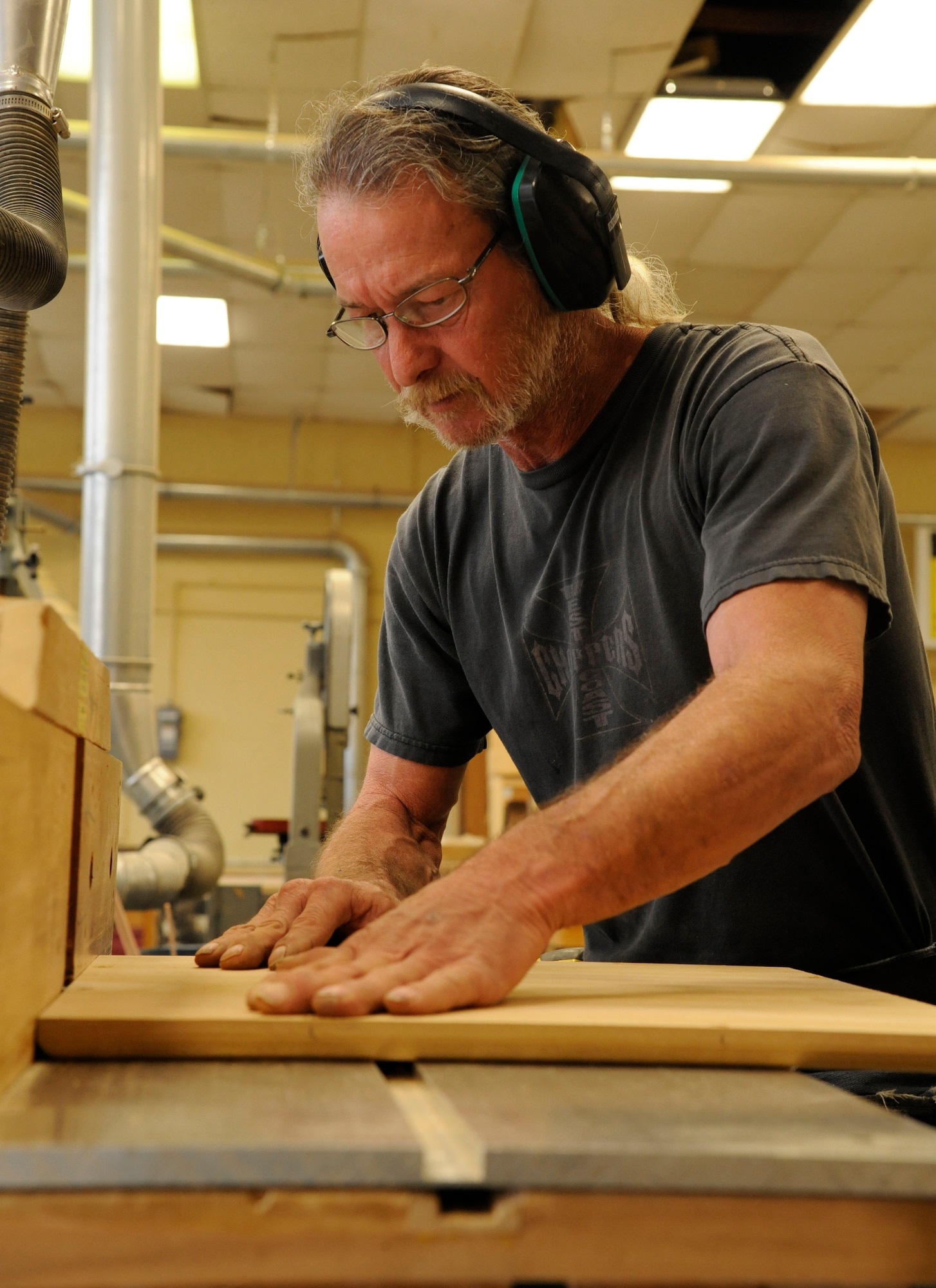 Mike Jarrett, 2nd Force Support Squadron woodcrafts center manager, uses a router to carve decorative edges during the construction of a shadowbox on Barksdale Air Force Base, La., April 10, 2013. The woodcraft shop receives approximately 30 requests per month that vary between shadowboxes, trophy cases, and going-away gifts. The woodcraft shop also offers a four-day class to teach members of Team Barksdale the basics of woodworking. (U.S. Air Force photo/Airman 1st Class Andrew Moua)