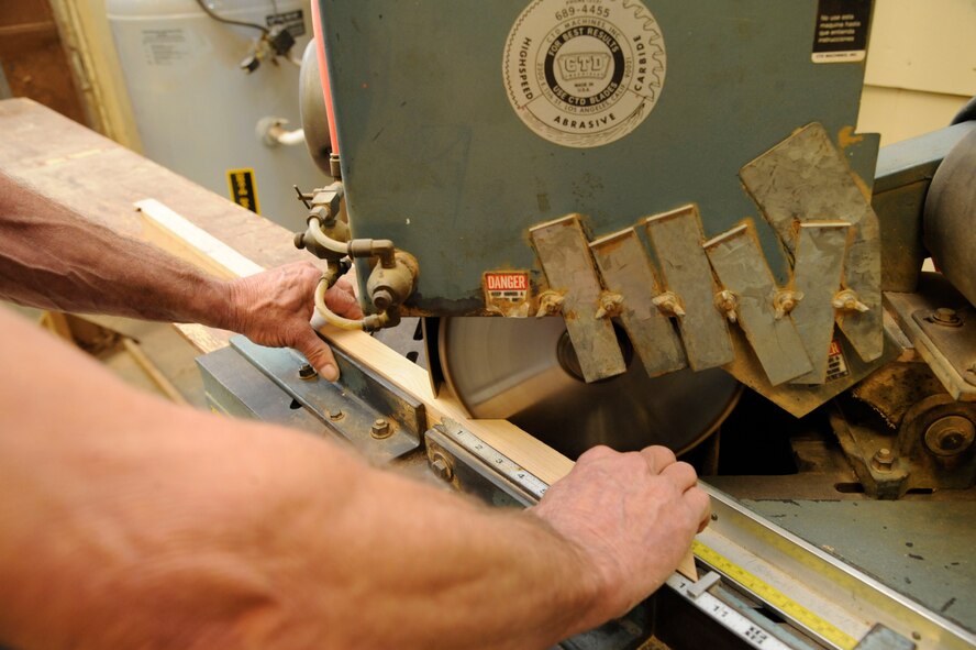 Mike Jarrett, 2nd Force Support Squadron woodcrafts center manager, saws a plank of wood during the construction of a shadowbox on Barksdale Air Force Base, La., April 10, 2013. A shadowbox holds and displays a retiring military member's awards and honors they have earned throughout their career. (U.S. Air Force photo/Airman 1st Class Andrew Moua)