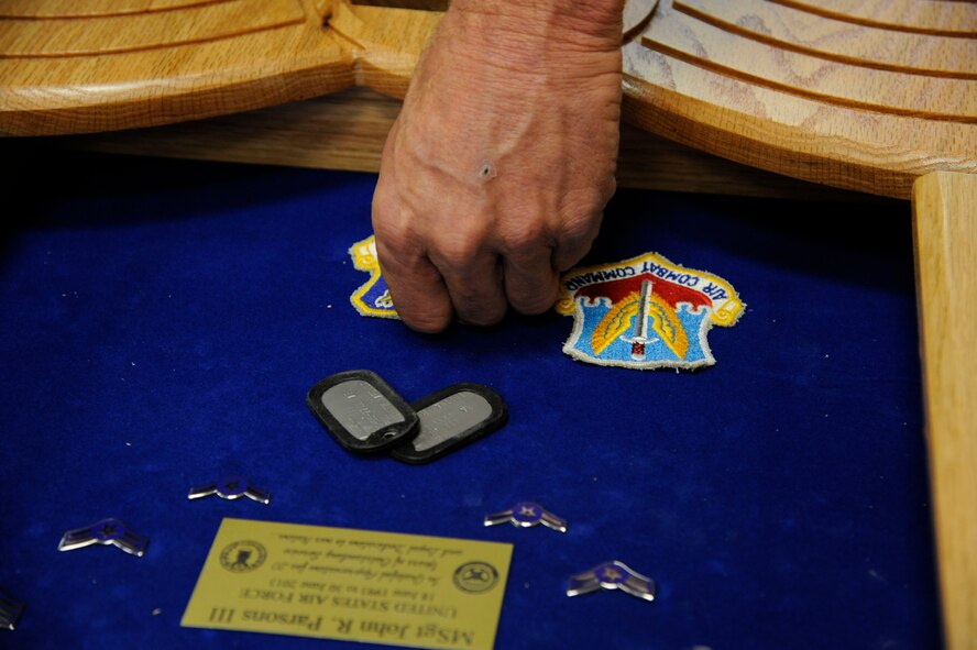 Mike Jarrett, 2nd Force Support Squadron woodcrafts center manager, positions unit emblems in a shadowbox on Barksdale Air Force Base, La., April 10, 2013. The woodcraft shop receives approximately 30 requests per month that vary between shadowboxes, trophy cases, and going-away gifts. The woodcraft shop also offers a four-day class to teach members of Team Barksdale the basics of woodworking. (U.S. Air Force photo/Airman 1st Class Andrew Moua)