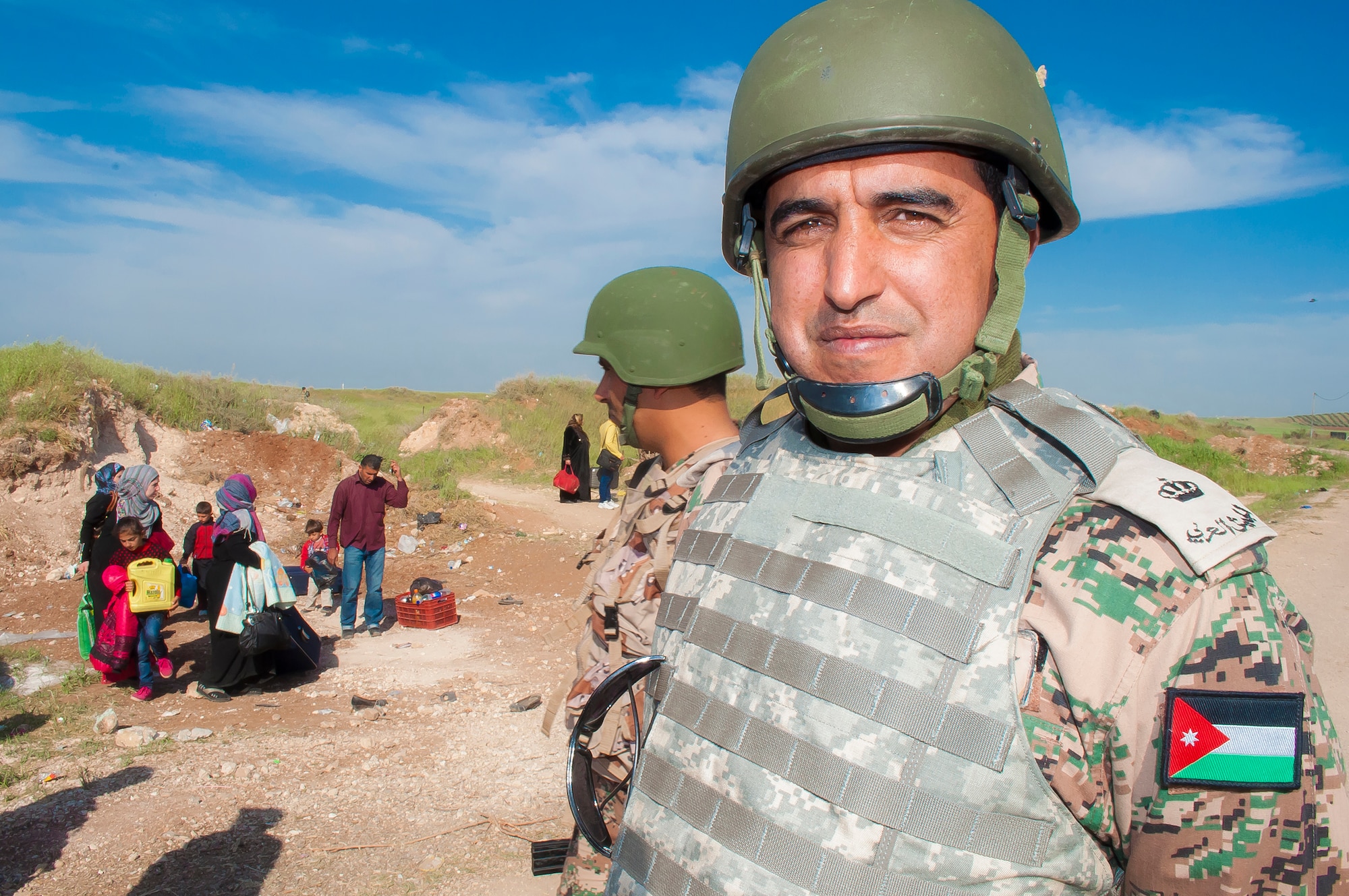 Jordan Armed Forces soldiers provide security for Syrian refugees at the Tal shehab Reception Center near Ash Shajarah in northern Jordan, April 2, 2013. Today alone, hundreds of men, women and children of all ages braved sniper fire in order to cross the border. Photographed here are just some of the 1.2 million refugees fleeing violence in their homeland. (US Air Force Photo by Air National Guard Capt. Darin Overstreet)