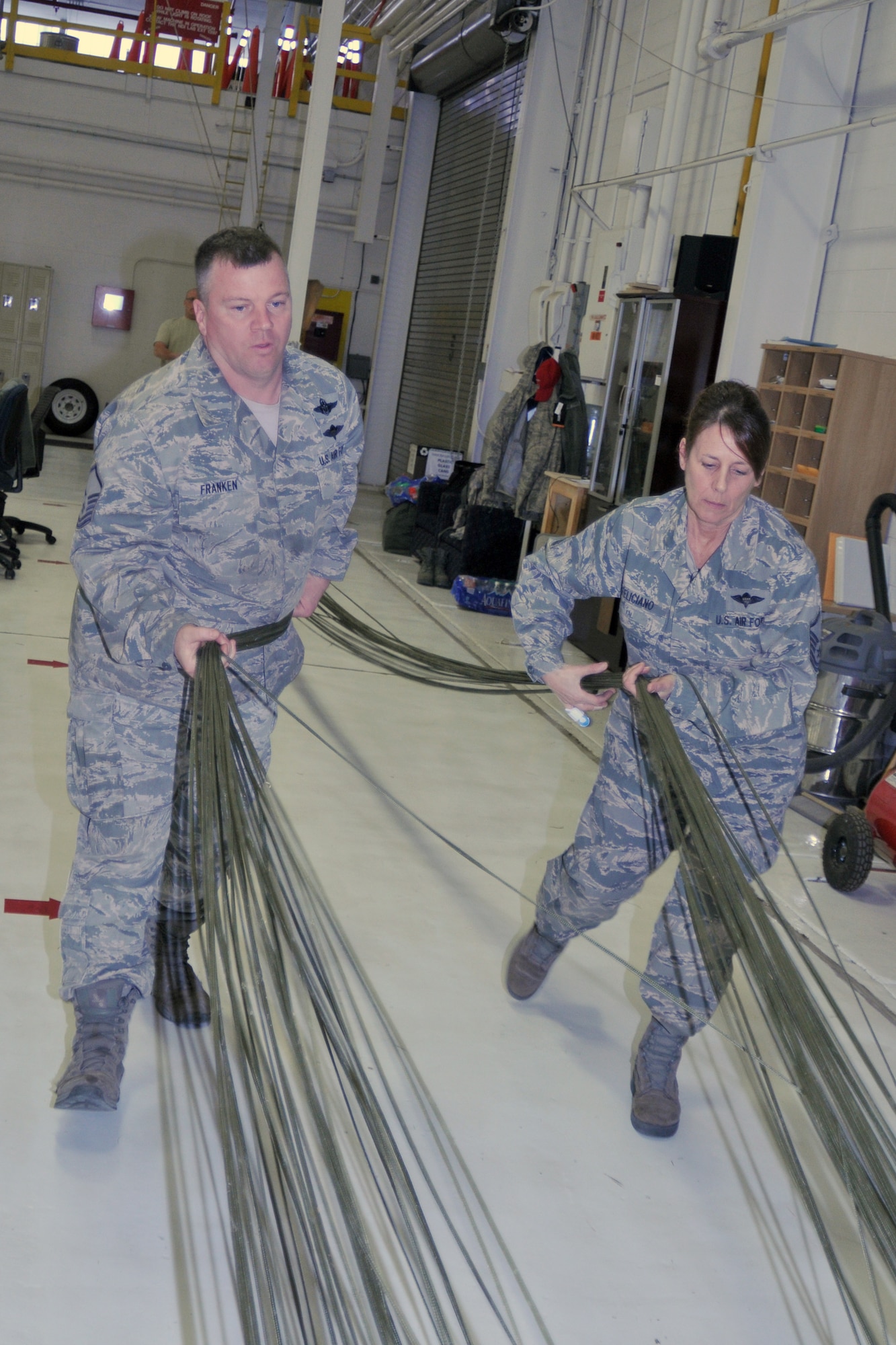 YOUNGSTOWN AIR RESERVE STATION, Ohio—Master Sgt. Brad Franken and Master Sgt. Christina Feliciano prepare a G12 parachute for packing on Saturday, April 6, 2013, here. Franken and Feliciano are aerial delivery maintainers for the 76th Aerial Port Squadron here. (U.S. Air Force photo/Technical Sergeant Jim Brock)
