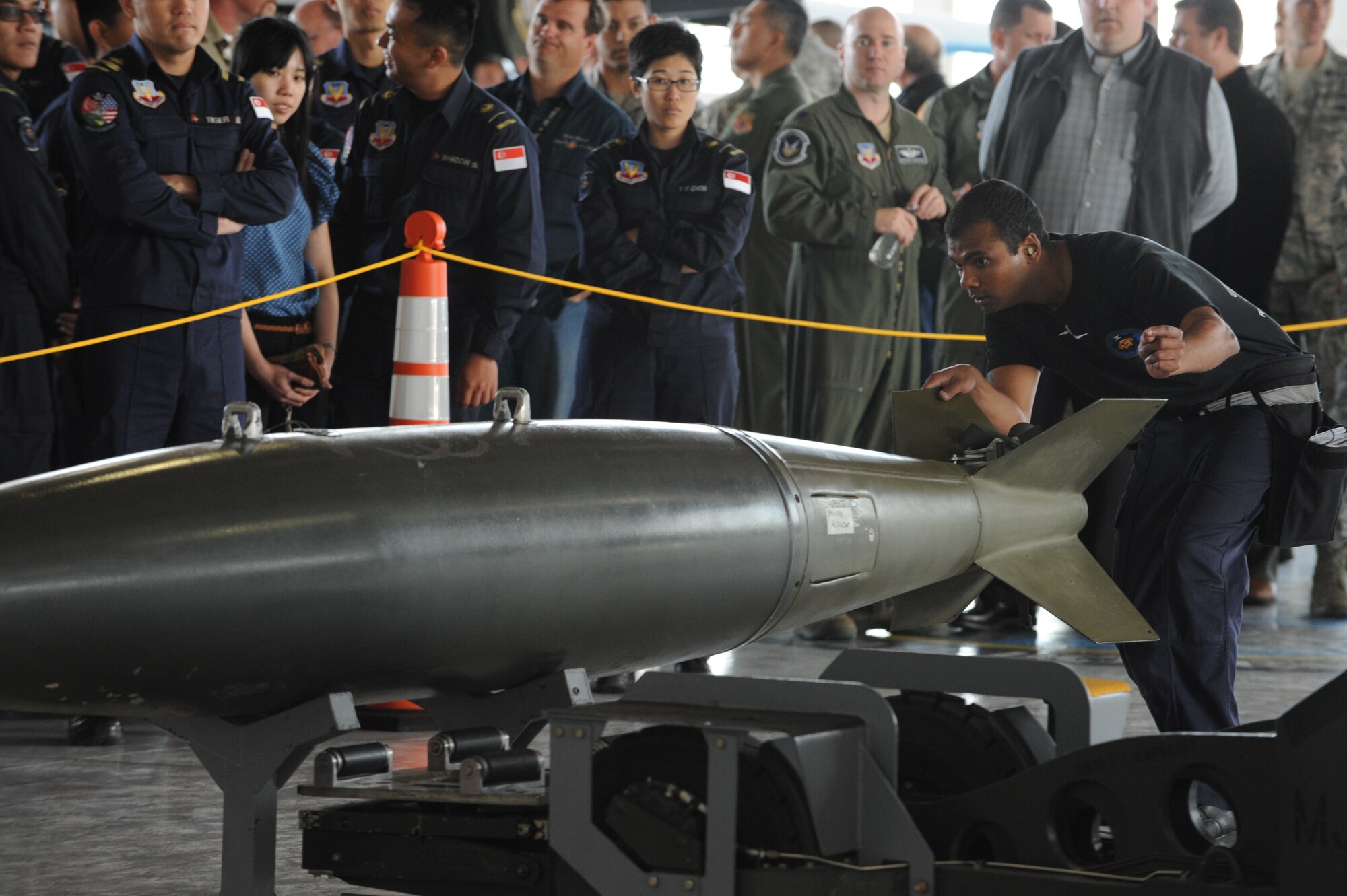 A Republic of Singapore Air Force service member inspects a weapon before loading it on to an F-15E Strike Eagle during a weapons load competition, April 5, 2013, at Mountain Home Air Force Base, Idaho. Each team worked together to efficiently and accurately load weaponry in the 15-minute time-frame. (U.S. Air Force Photo/Airman 1st Class Malissa Lott)