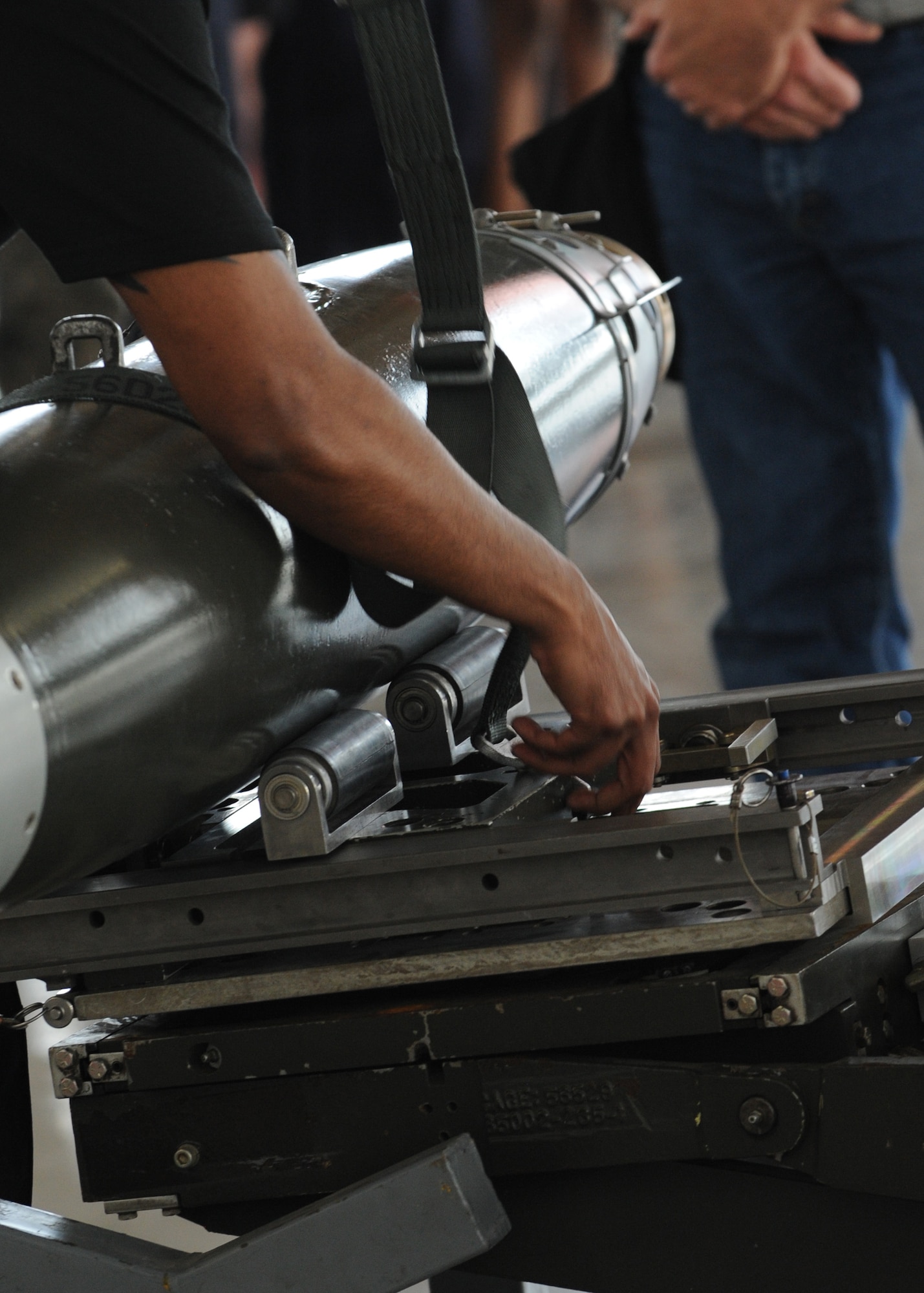 A Republic of Singapore Air Force service member loads a weapon on an F-15E Strike Eagle during a weapons load competition, April 5, 2013, at Mountain Home Air Force Base, Idaho. The teams had 15 minutes to load their equipment to test their speed and accuracy. (U.S. Air Force Photo/Airman 1st Class Malissa Lott)