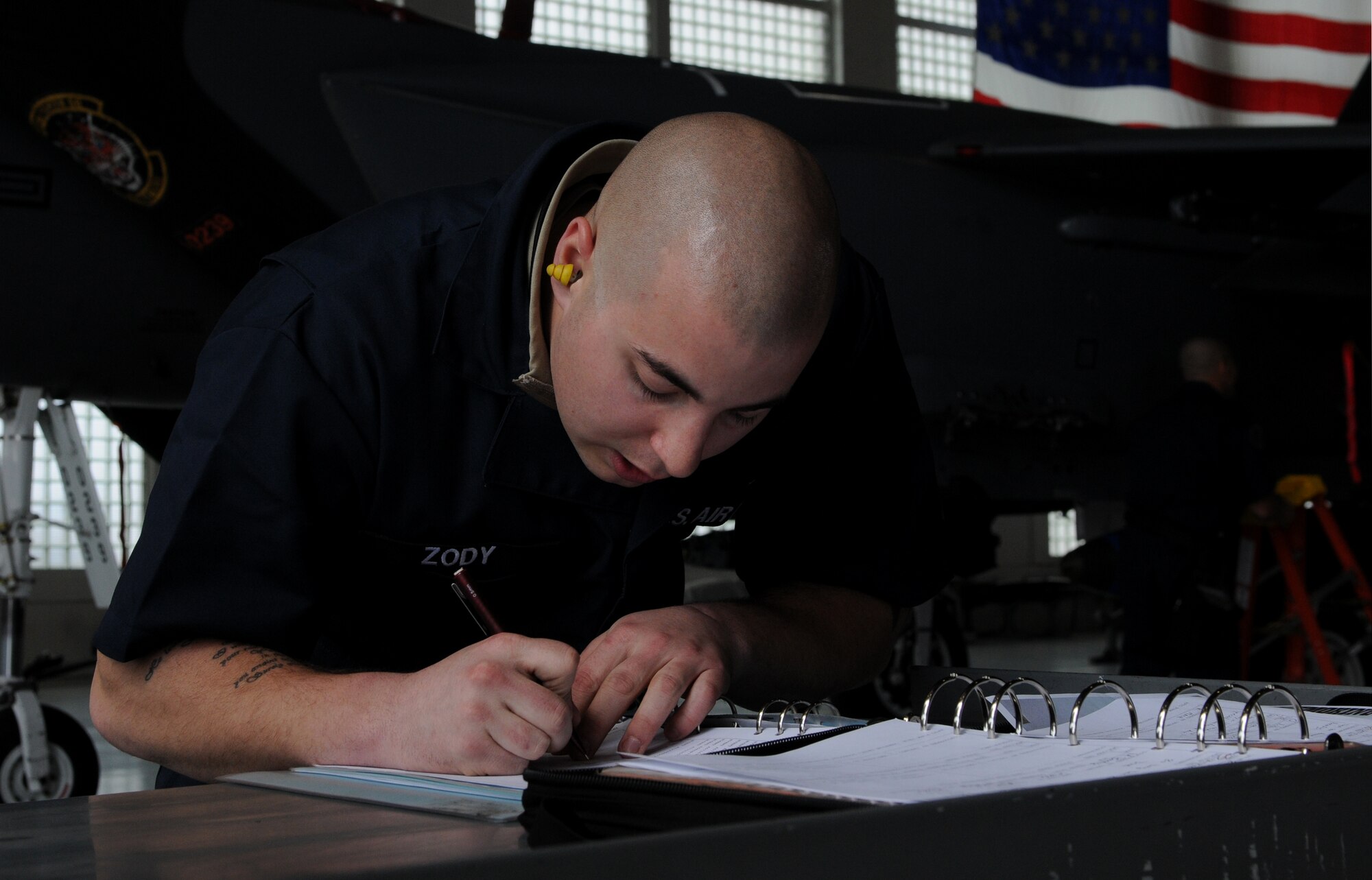 U.S. Air Force Senior Airman Caleb Zody, 391st Aircraft Maintenance Unit weapons load team crewman, writes down information during weapons load competition at Mountain Home Air Force Base, Idaho, April 5, 2013. The competition allows the top crew from each unit to compete against each other to see which team can complete the weapons load the quickest and most accurately. (U.S. Air Force photo/Senior Airman Heather Hayward)