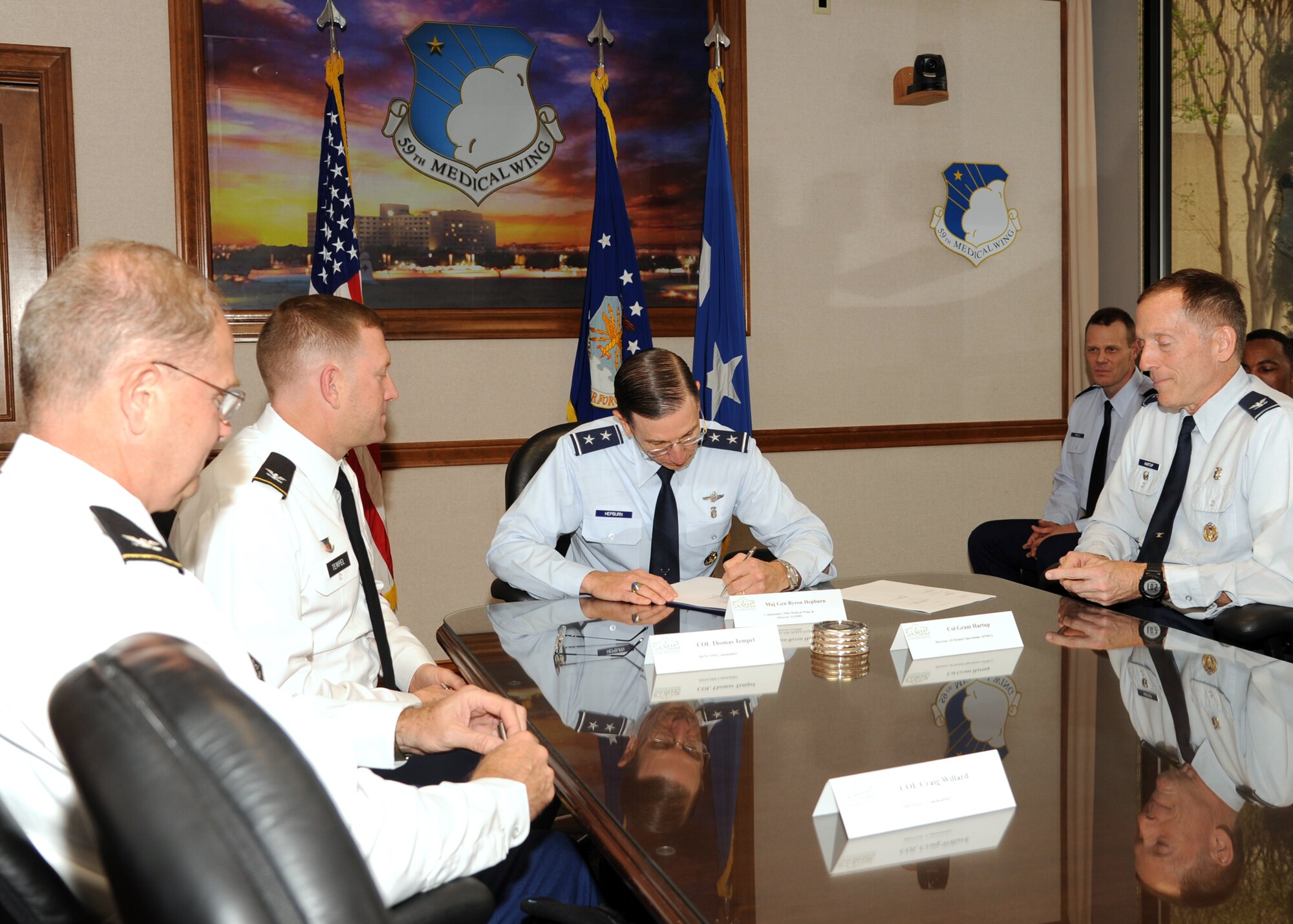 Army Col. Thomas Temple, Col. Craig Willard, Air Force Maj. Gen. Byron Hepburn and Col. Grant Hartup gather to sign a Memorandum of Agreement establishing the integration of the 59th Medical Wing and Fort Sam Houston Dental Activity’s Oral and Maxillofacial Surgery Residency Programs at Wilford Hall Ambulatory Surgical Center, Joint Base San Antonio-Lackland, Texas, April 2. Temple is commander of the Fort Sam Dental Command, Willard is commander of the Army Dental Activity, Hepburn is the San Antonio Military Health System director and commander of the 59th Medical Wing and Hartup is director of the Air Force Dental Operations, Air Force Medical Operations Agency.
