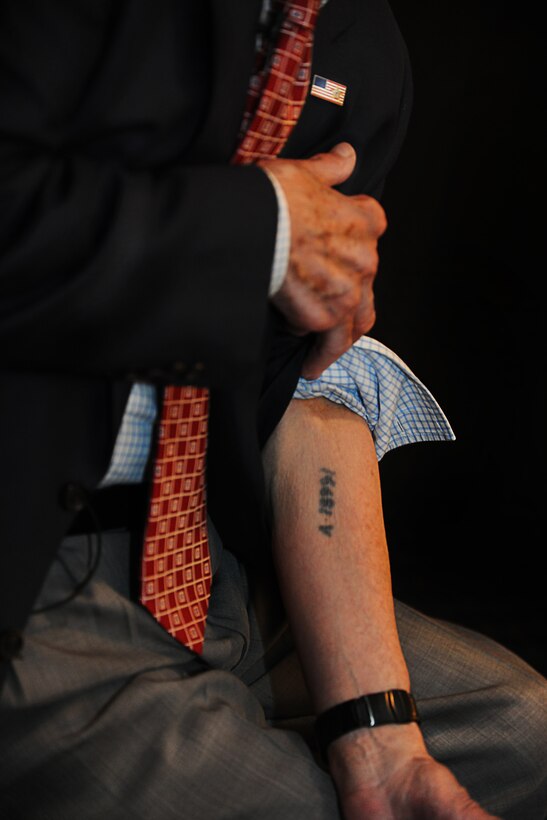 Henry Greenbaum, a holocaust survivor, displays his identification tattoo from Auschwitz Concentration Camp while visiting Joint Base Andrews, Md., April 9, 2013. Greenbaum spoke to members of JBA about his losses, struggle, and eventually, his liberation by American forces. Following his story, Greenbaum allowed for a question and answer session, which he discussed his resiliency and faith, which helped him through the Holocaust. (U.S. Air Force photo/Senior Airman Lauren Main)
