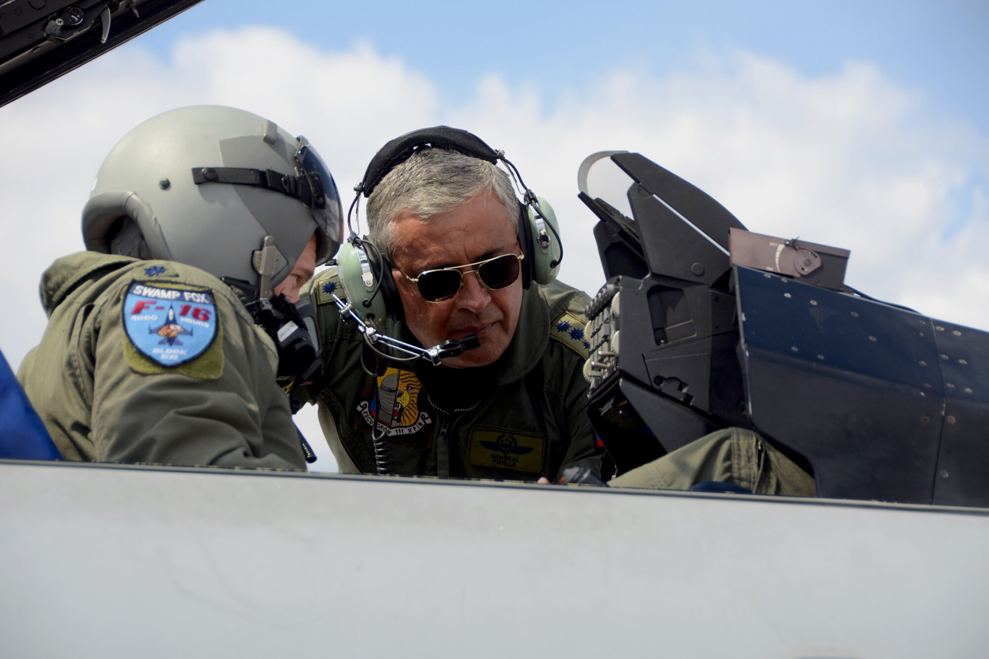 General Tito Saul Pinilla Pinilla, commander of the Colombian Air Force, speaks with Lt. Col. Scott Bridgers, 169th Aircraft Maintenance Squadron commander and F-16 fighter pilot during an avionics demo, as part of his tour of McEntire Joint National Guard Base, S.C., April 8, 2013. The Adjutant General of South Carolina, Maj. Gen. Robert E. Livingston, Jr., hosted Pinilla for the latest engagement of the newly formed State Partnership Program between South Carolina and the Republic of Colombia. Pinilla toured the Air Guard's F-16 and the Army Guard's rotary wing facilities and received briefings about their capabilities.
(National Guard photo by Tech. Sgt. Caycee Watson/Released)