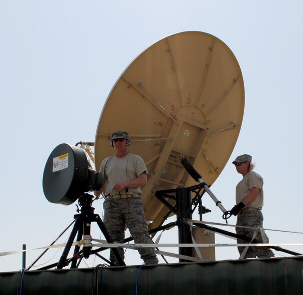 Master Sgt. Aaron Smith Jr. fine tunes a radio frequency module shot to the Marine Forces Africa command center while Master Sgt. Megan Reed ensures the primary satellite communications antenna is stable in support of African Lion 2013 in Morocco on April 9. Smith and Reed are both assigned to the 55th Combat Communications Squadron, Robins Air Force Base, Ga. African Lion is an annually scheduled, bilateral U.S. and Moroccan sponsored exercise designed to improve interoperability and mutual understanding of each nation's tactics, techniques and procedures. This year, the 55th CBCS was selected to provide communications support for the exercise. (U.S. Air Force photo by SrA. Will Toussaint)