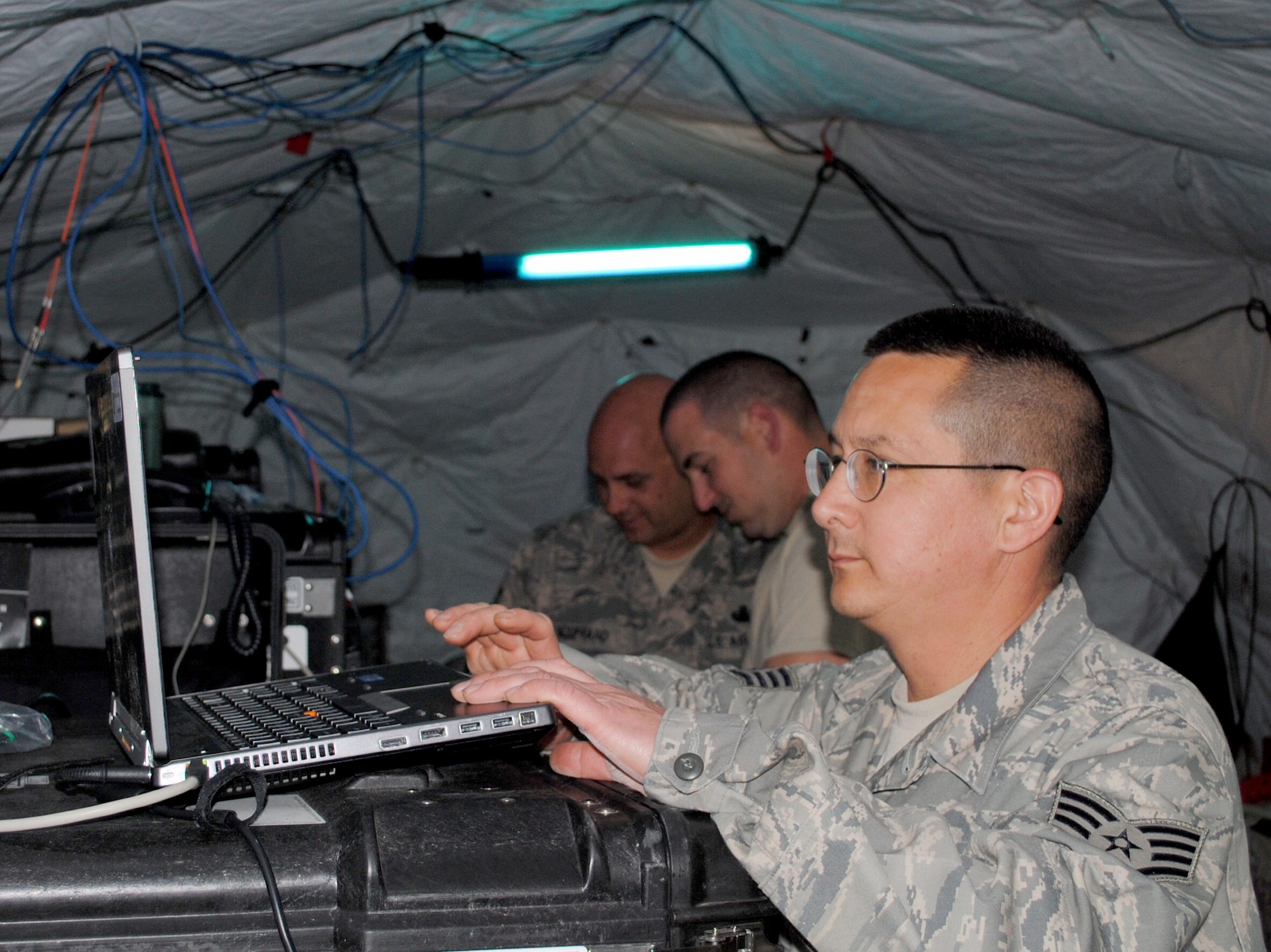 Staff Sgt. Johnny Linch, foreground, double checks settings for network routing while Master Sgt. Lou Bouffard and Staff Sgt. Michael Russano, all of the 55th Combat Communications Squadron, Robins Air Force Base, Ga., configure settings on network servers in support of African Lion 2013 in Morocco on April 9. African Lion is an annually scheduled, bilateral U.S. and Moroccan sponsored exercise designed to improve interoperability and mutual understanding of each nation's tactics, techniques and procedures. This year, the 55th CBCS was selected to provide communications support for the exercise. (U.S. Air Force photo/SrA. Will Toussaint)