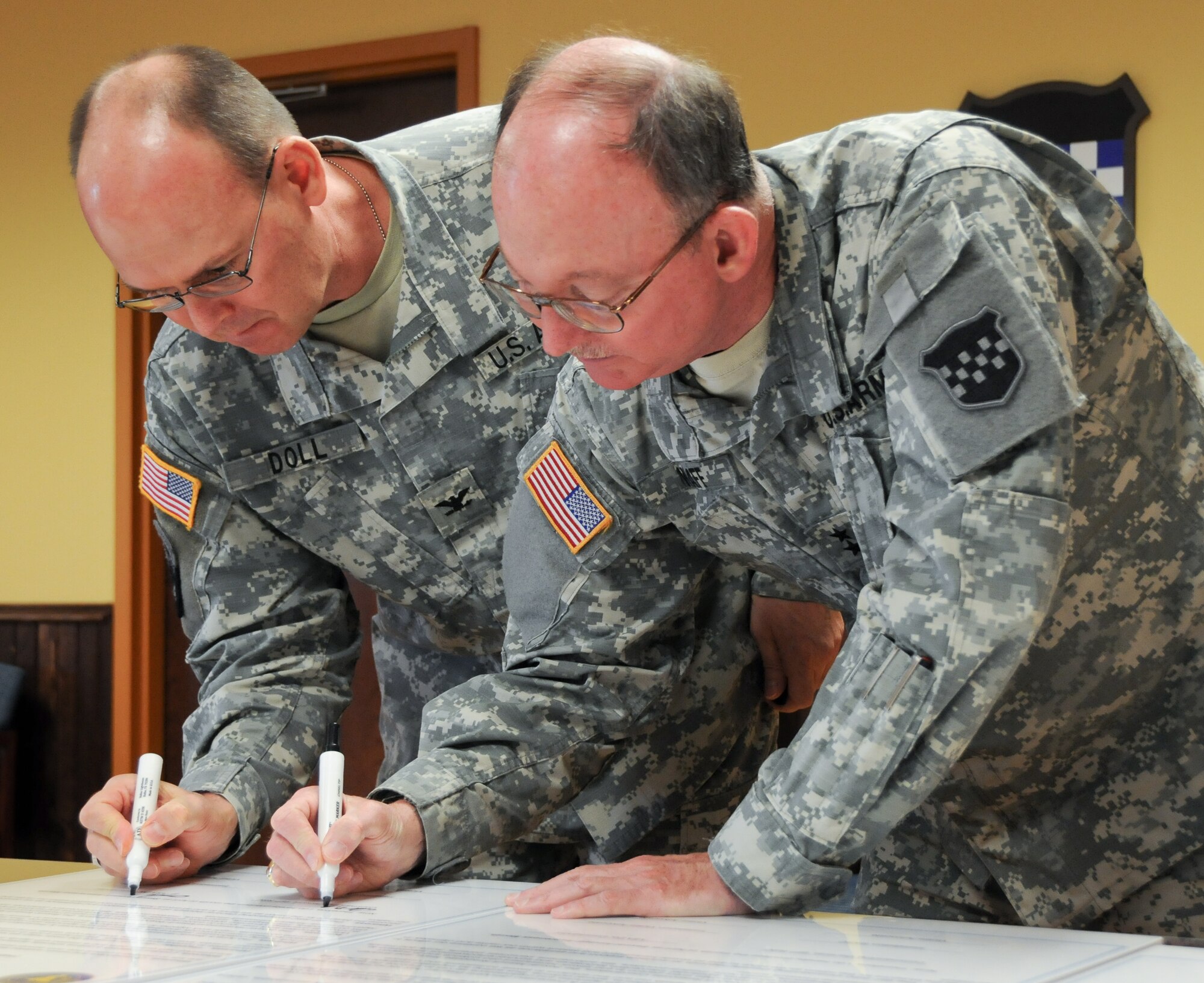 Maj. Gen. William D. Razz Waff, 99th Regional Support Command commander, and Col. Jeff Doll, Army Support Activity-Dix commander, sign a joint proclamation at the Maj. John P. Pryor Army Reserve Center at Joint Base McGuire-Dix-Lakehurst, N.J., in support of Sexual Assault Awareness Month April 3, 2013. The proclamation highlights the role the Sexual Harassment and Assault Response and Prevention Program plays in reinforcing the Army's commitment to eliminate sexual harassment and sexual assault incidents through awareness and prevention, training, victim advocacy, reporting and accountability. (U.S. Army photo by Staff Sgt. Shawn Morris/Released)