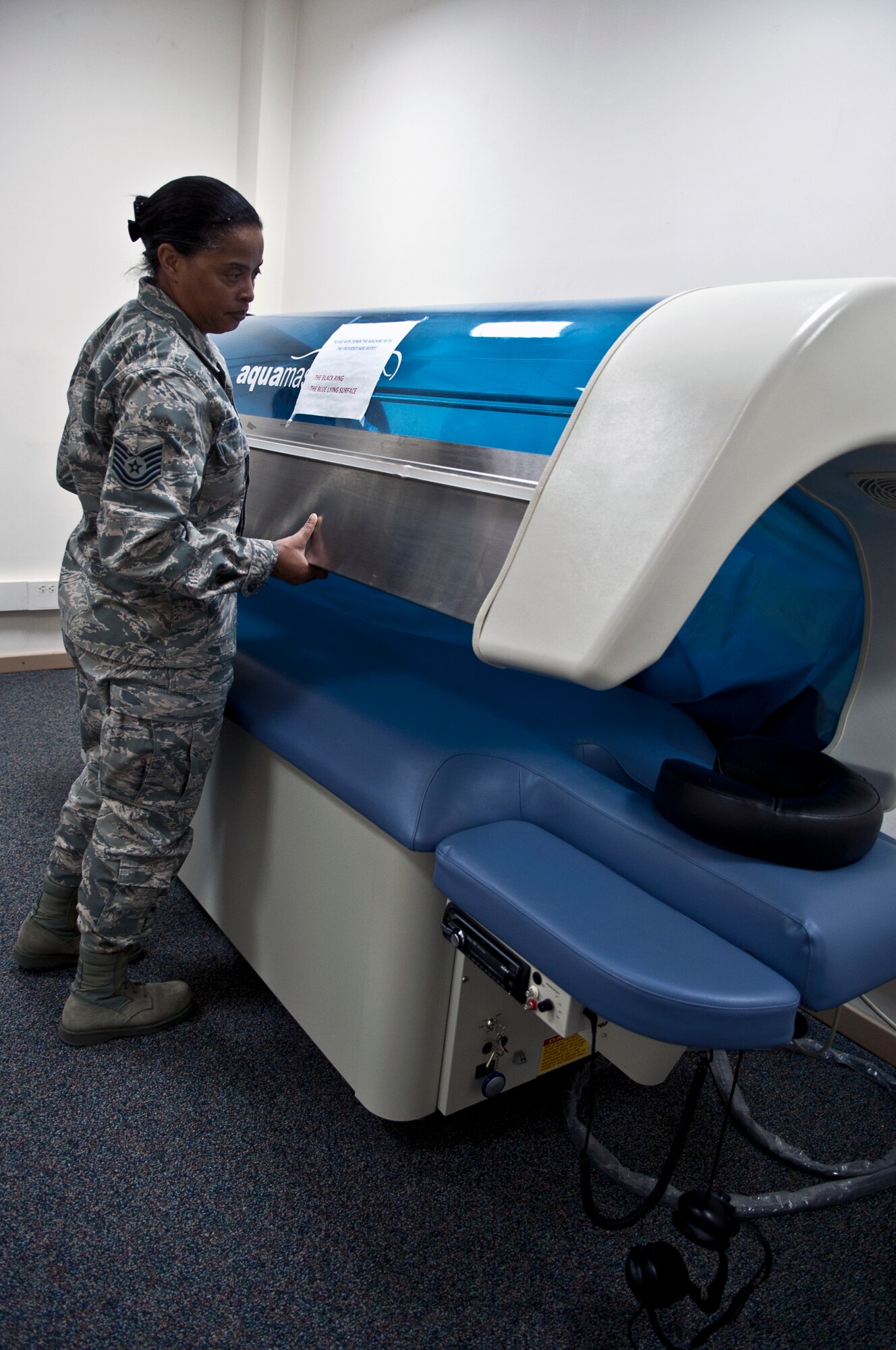 Tech. Sgt. Stephanie Garner, 39th Medical Operations Squadron nutritionist, inspects a water massage machine March 29, 2013, at Incirlik Air Base, Turkey. The HAWC promotes health and wellness for military members and their families by providing guidance on how to meet their nutrition and fitness goals. (U.S. Air Force photo by Senior Airman Daniel Phelps/Released)