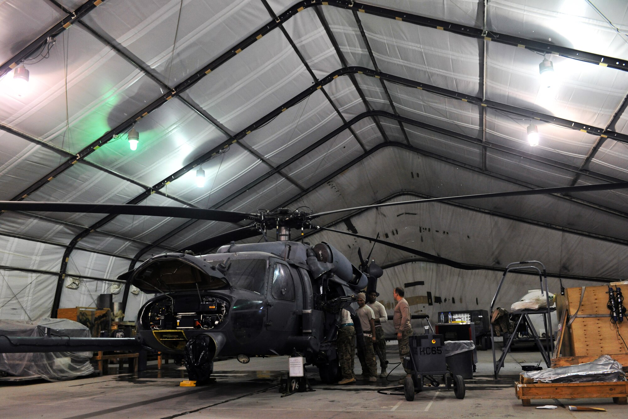 Members of the 455th Expeditionary Aircraft Maintenance Squadron 83rd Helicopter Maintenance Unit work on a HH-60 Pave Hawk helicopter on Bagram Airfield, Afghanistan, April 9, 2013. The 83rd HMU's primary mission is to ensure that Bagram's fleet of HH-60 Pave Hawk helicopters are safe and combat-ready so their aircrew and pararescuemen can go out and perform their rescue missions in support of Operation Enduring Freedom. (U.S. Air Force photo/Senior Airman Chris Willis)