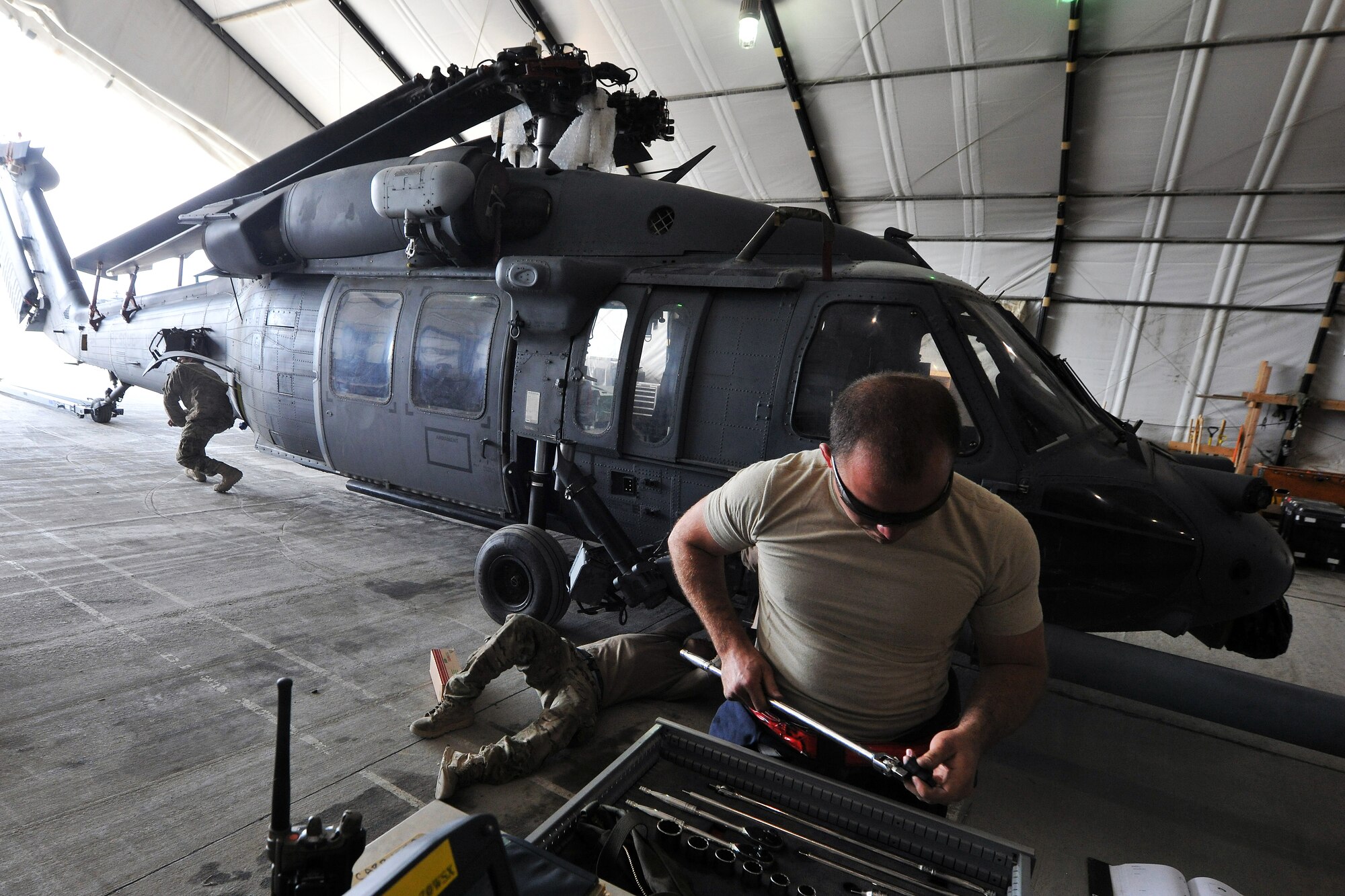 Senior Airman Michael Carrubba, 455th Expeditionary Aircraft Maintenance Squadron 83rd Helicopter Maintenance Unit assistant dedicated crew chief, prepares to work on a HH-60 Pave Hawk helicopter on Bagram Airfield, Afghanistan, April 9, 2013. The 83rd HMU's primary mission is to ensure that Bagram's fleet of HH-60 Pave Hawk helicopters are safe and combat-ready so their aircrew and pararescuemen can perform their rescue missions in support of Operation Enduring Freedom. (U.S. Air Force photo/Senior Airman Chris Willis)