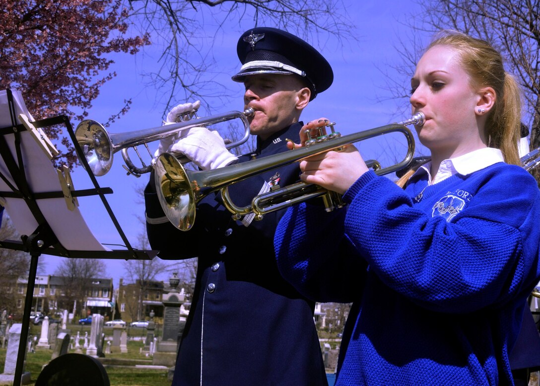 Tech. Sgt. Brian Stiles, member of the U.S. Air Force Band, and a trumpeter from The Wynford High School Band play selections from composer John Philip Sousa during an afternoon performance at Congressional Cemetery in Washington, D.C. on March 23, 2013. The bands spent the afternoon honoring Sousa by playing some of his most-famous marches together at his gravesite. (U.S. Air Force photo/Senior Airman Lindsey A. Porter)