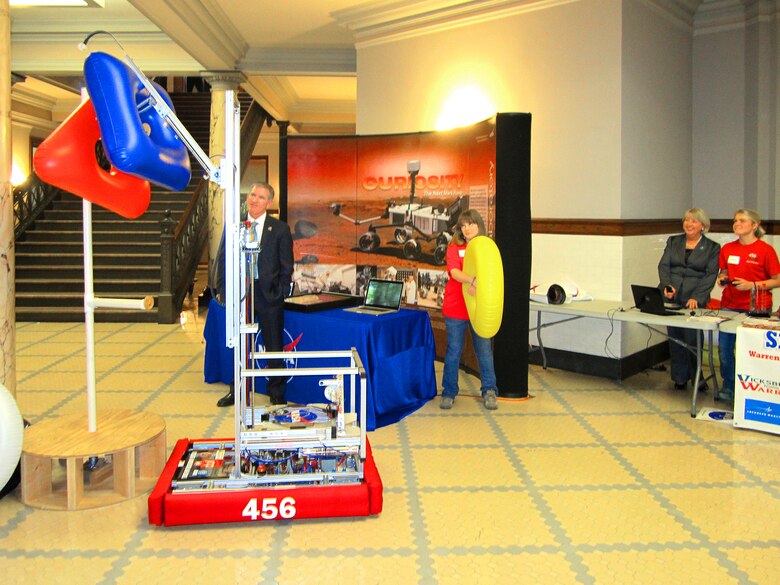Mississippi first lady Deborah Bryant, second from right, gets a feel for what the robot can do as others look on.