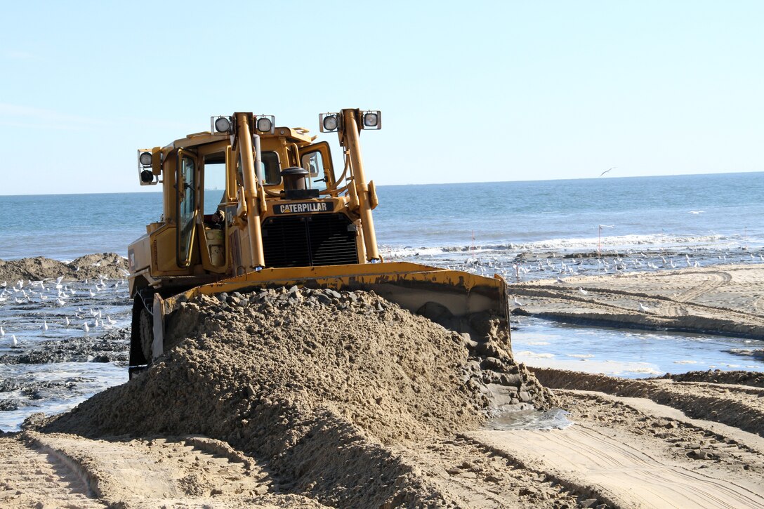 VIRGINIA BEACH, Va. -– Dozers move sand as the dredge pipes it in from the ocean floor. This project is part of the Hurricane Protection Beach Renourishment Project in Virginia Beach and is the first renourishment since the project was completed in 2001.