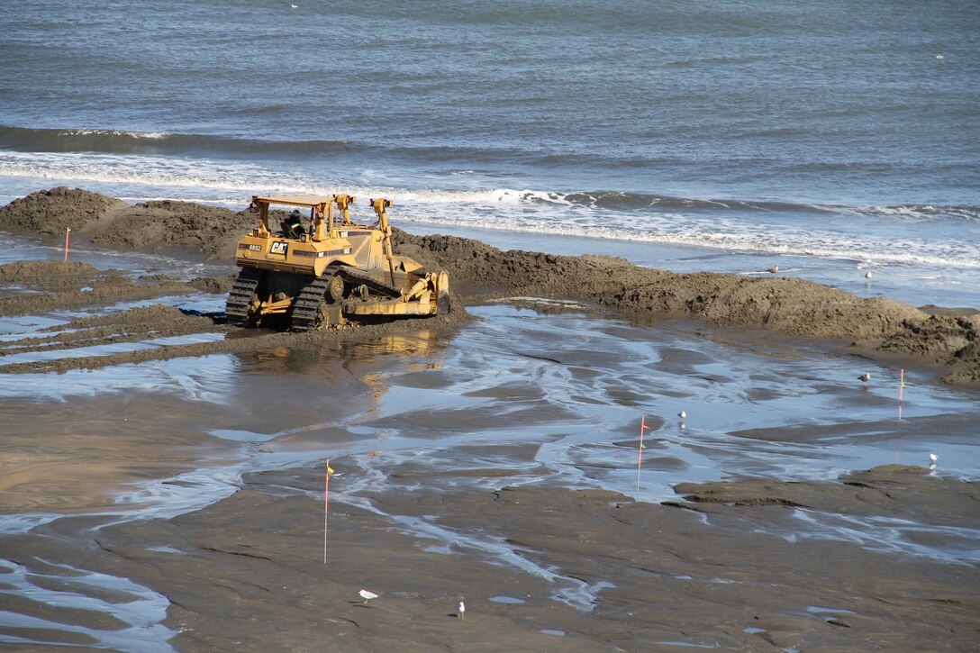 VIRGINIA BEACH, Va. -– Dozers move sand as the dredge pipes it in from the ocean floor. This project is part of the Virginia Beach Hurricane Protection Beach Renourishment Project and is the first renourishment since the project was completed in 2001. The $143 million storm protection project in 2001 included spanning the original boardwalk, adding pump stations, seawall improvements and sand replenishment.