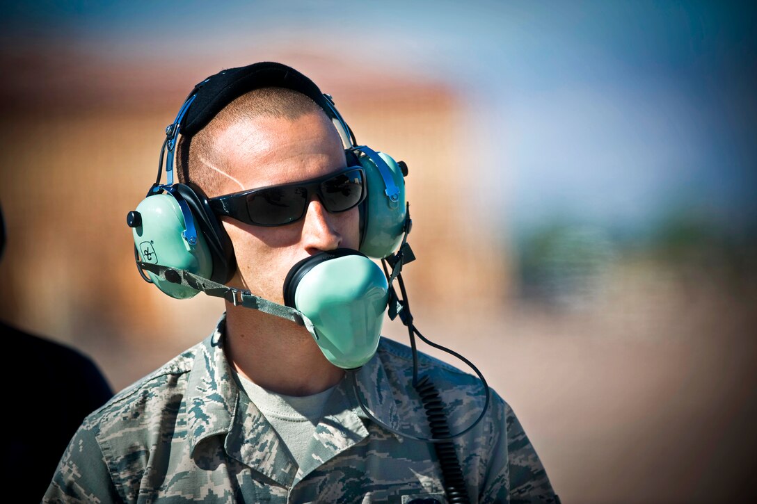 Air Force Senior Airman Alexander Orchard communicates via headset to the F-35A Lightning II aircraft pilot before a training mission on Nellis Air Force Base, Nev., April 2, 2013. Orchard, a crew chief, is assigned to the 57th Aircraft Maintenance Squadron. The F-35A is assigned to the 422nd Test and Evaluation Squadron and maintained by the 57 AMXS Lightning aircraft maintenance unit.