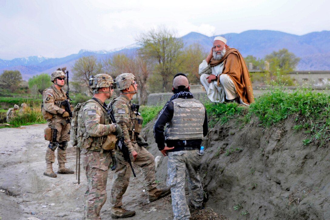 U.S. soldiers talk with an Afghan during a patrol near a village in the Khogyani district of Afghanistan’s Nangarhar province, March 29, 2013.