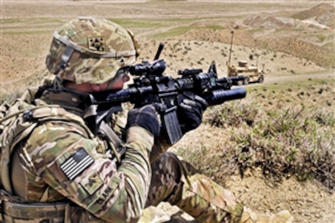 U.S. Army Sgt. Joshua J. Clark provides security for U.S. Air Force Explosive Ordinance Disposal personnel outside an Afghan border police checkpoint near the Afghanistan-Pakistan border in the Spin Boldak district of Afghanistan’s Kandahar province, April 1, 2013. Clark is assigned to the 591st Engineer Company, 23rd Infantry Regiment, 4th Striker Brigade Combat Team, Security Force Assistance Team 7. 