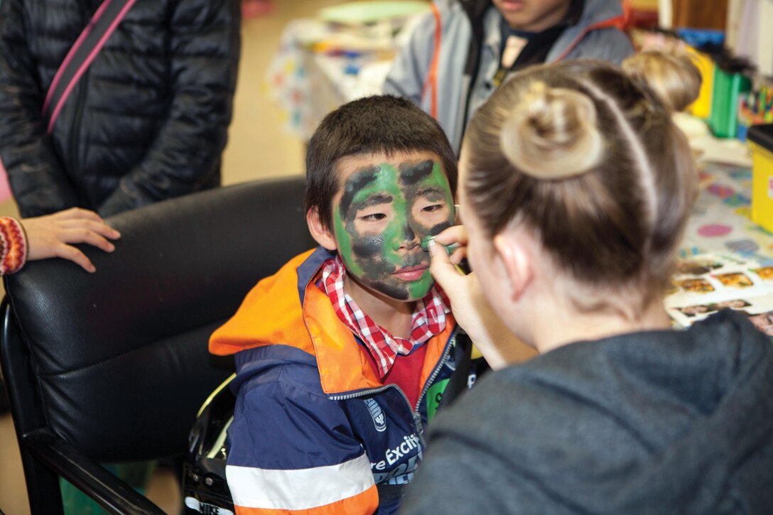 Sho Takata gets his face painted March 30 during an annual festival celebrating both Easter and the spring season at Combined Arms Training Center Camp Fuji, Japan. The children came to Camp Fuji from nearby orphanages for a day of fun and games with Marines and sailors. Photo by Cpl. Adam B. Miller