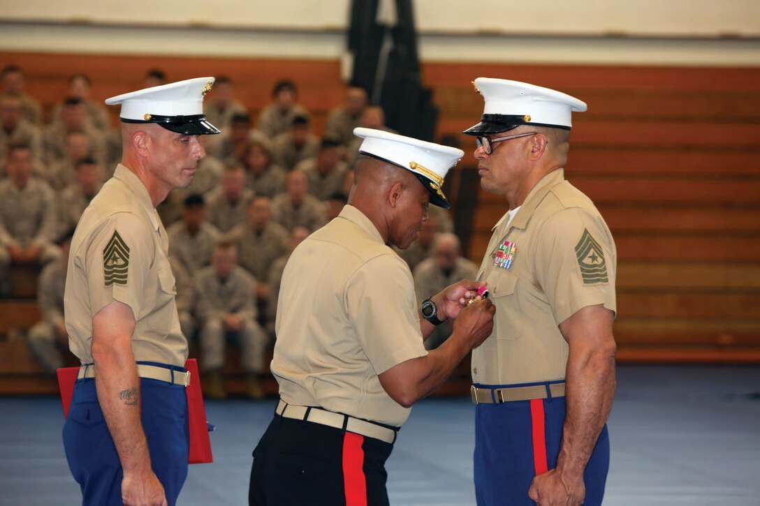 Brig. Gen. Craig Q. Timberlake presents Sgt. Maj. Robert L. Caldwell the Legion of Merit Medal March 29 during Caldwell’s retirement ceremony at Camp Hansen. Caldwell was recognized for 30 years of service to the Marine Corps and nation during the ceremony. Timberlake is the deputy commanding general of III Marine Expeditionary Force and commanding general of 3rd Marine Expeditionary Brigade. Caldwell most recently served as the sergeant major of 3rd Marine Expeditionary Brigade, III MEF Headquarters Group and Camp Hansen. Photo by Cpl. Matthew Manning