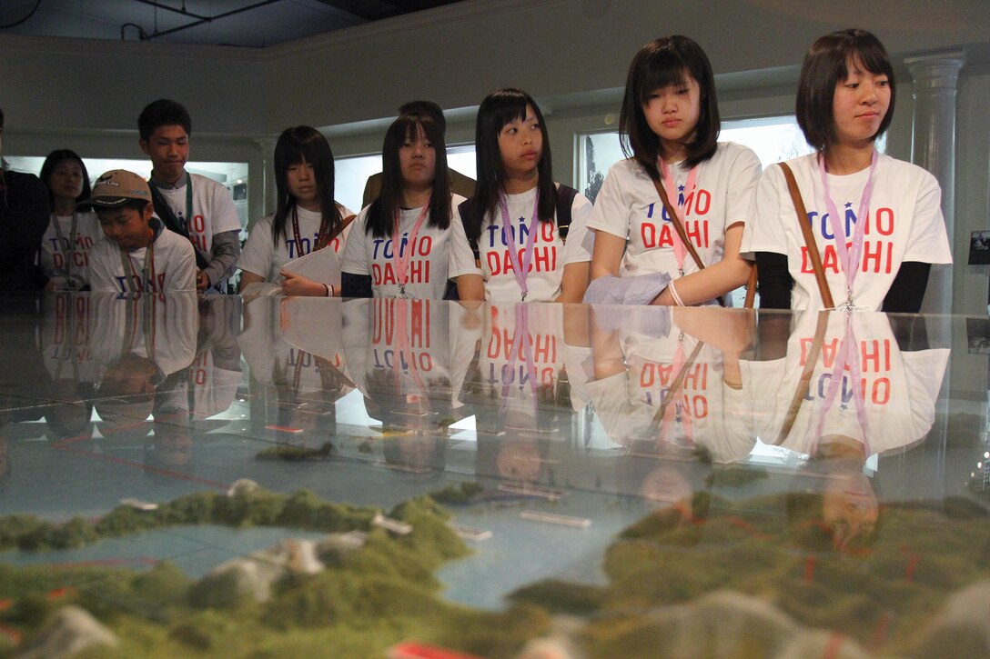Students from Kesennuma High School on the Japanese island of Oshima view a display of the Asia-Pacific region in the Marine Corps Recruit Depot San Diego command museum during their visit March 26. A handful of students visited Marines and sailors who participated in Operation Tomodachi for an opportunity to thank the service members. Operation Tomodachi was a humanitarian assistance and disaster relief operation following the Great East Japan Earthquake and subsequent tsunami, which occurred more than two years ago. Photo by Cpl. Matheus J. Hernandez