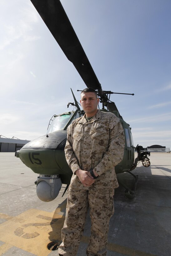Cpl. Fabian Cardona stands in front of a UH-1N Huey on the Cherry Point flight line April 3. 